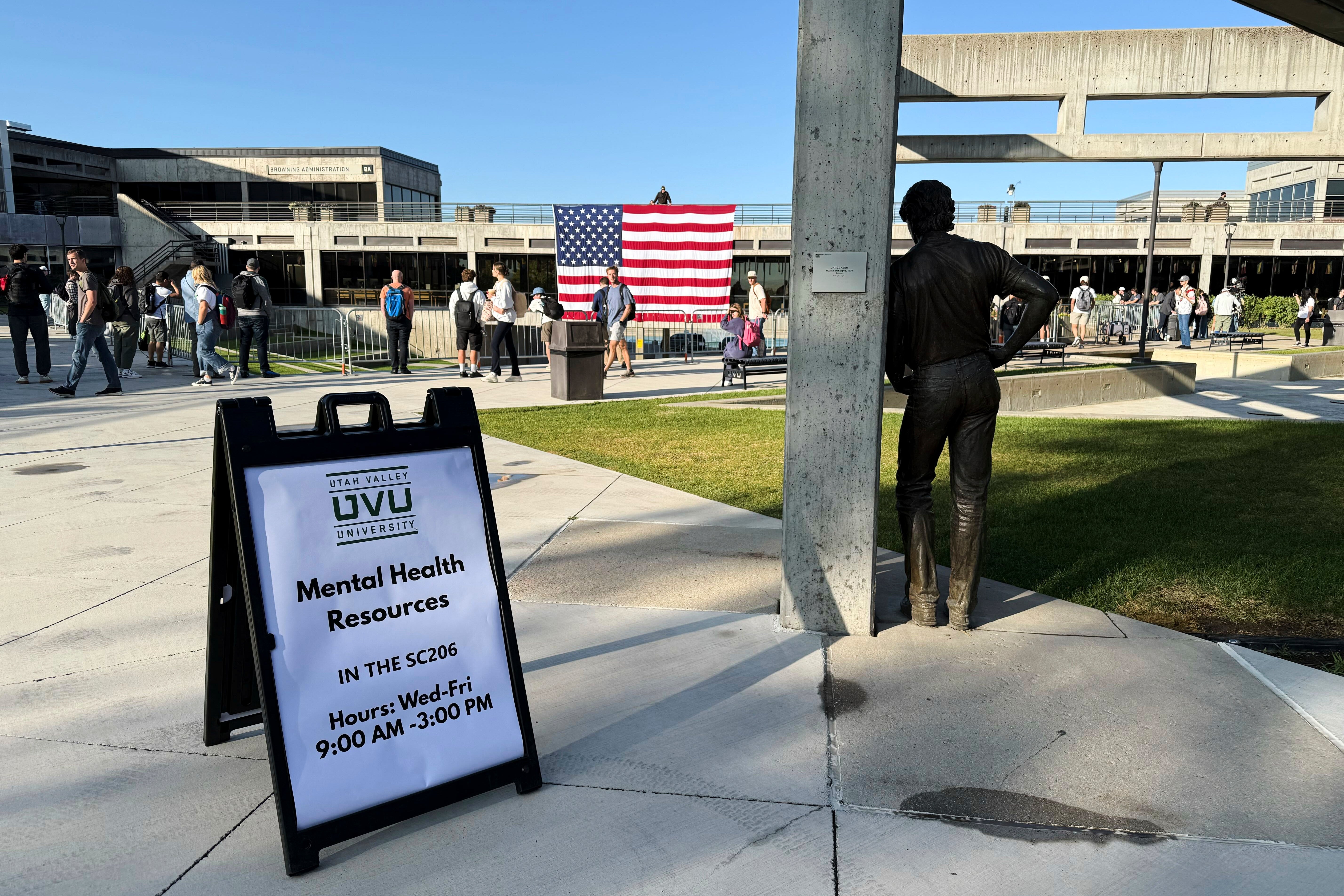 Students walk past a 'Mental Health Resources' sign on the Utah Valley University campus on Wednesday. The school is set to hold a 'Vigil for Unity' on Friday