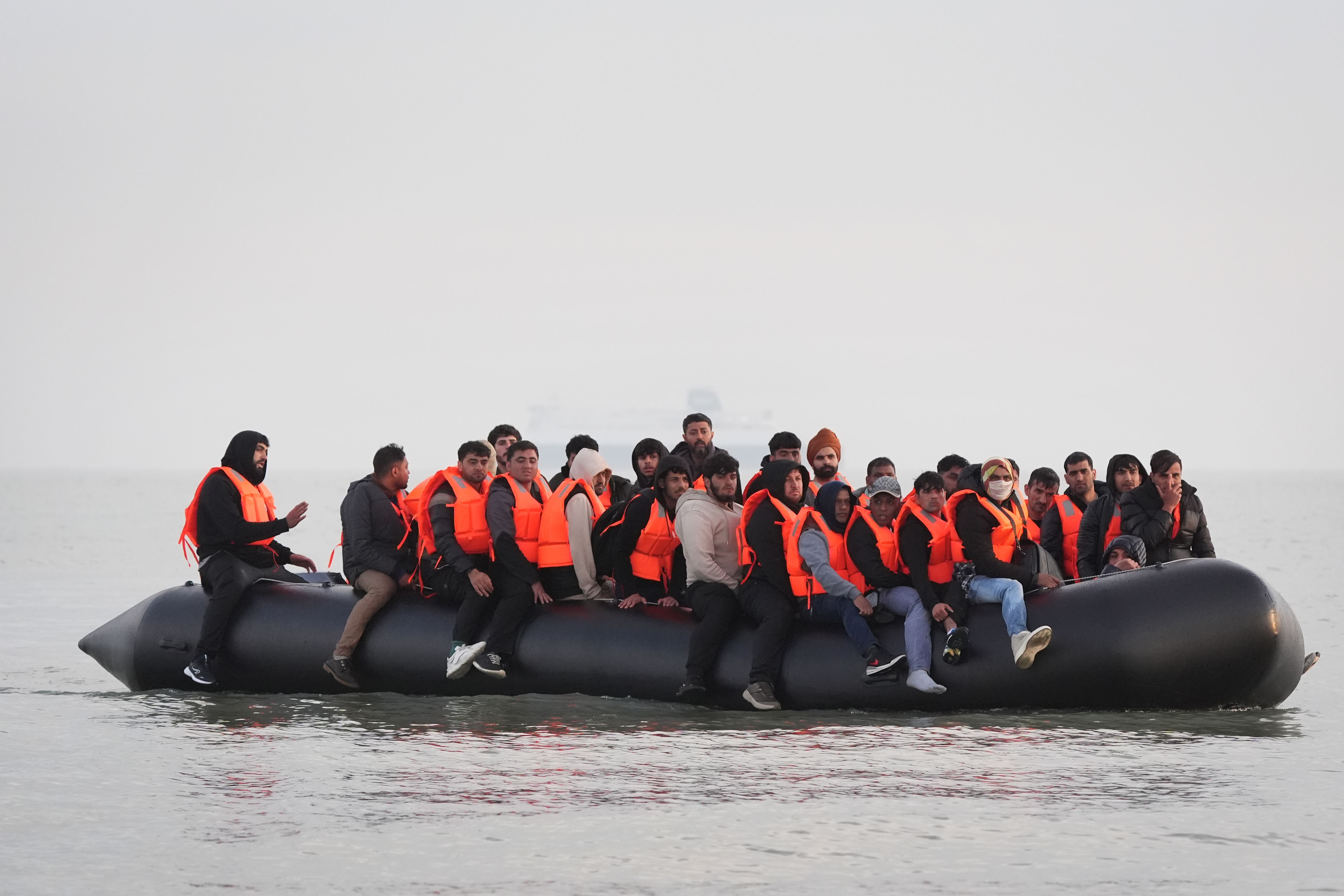 A group of people thought to be migrants onboard a small boat leaving a beach in France, attempting to reach the UK by crossing the English Channel (PA)