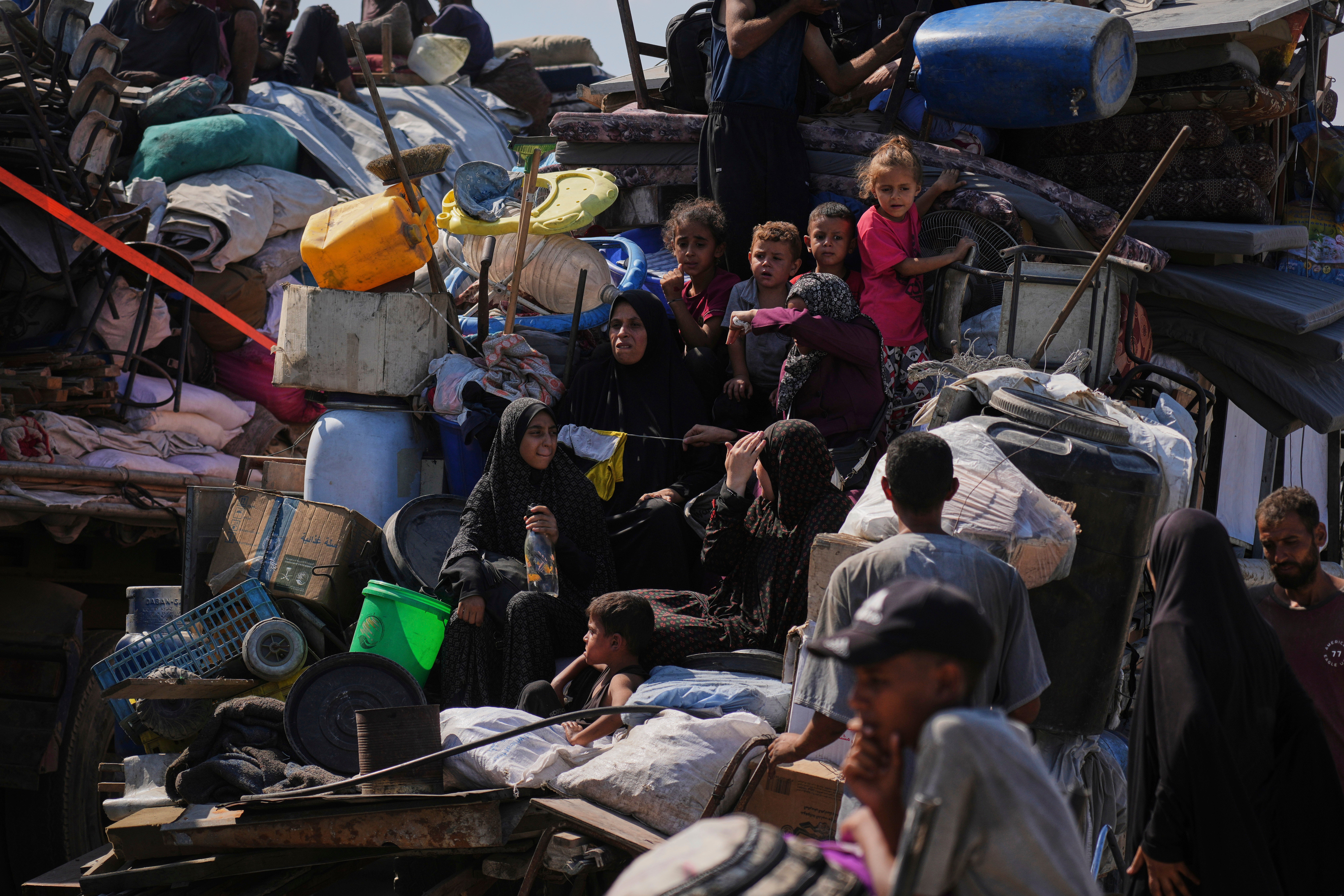 Displaced Palestinians flee Gaza City by foot and vehicles, carrying their belongings along the coastal road toward southern Gaza