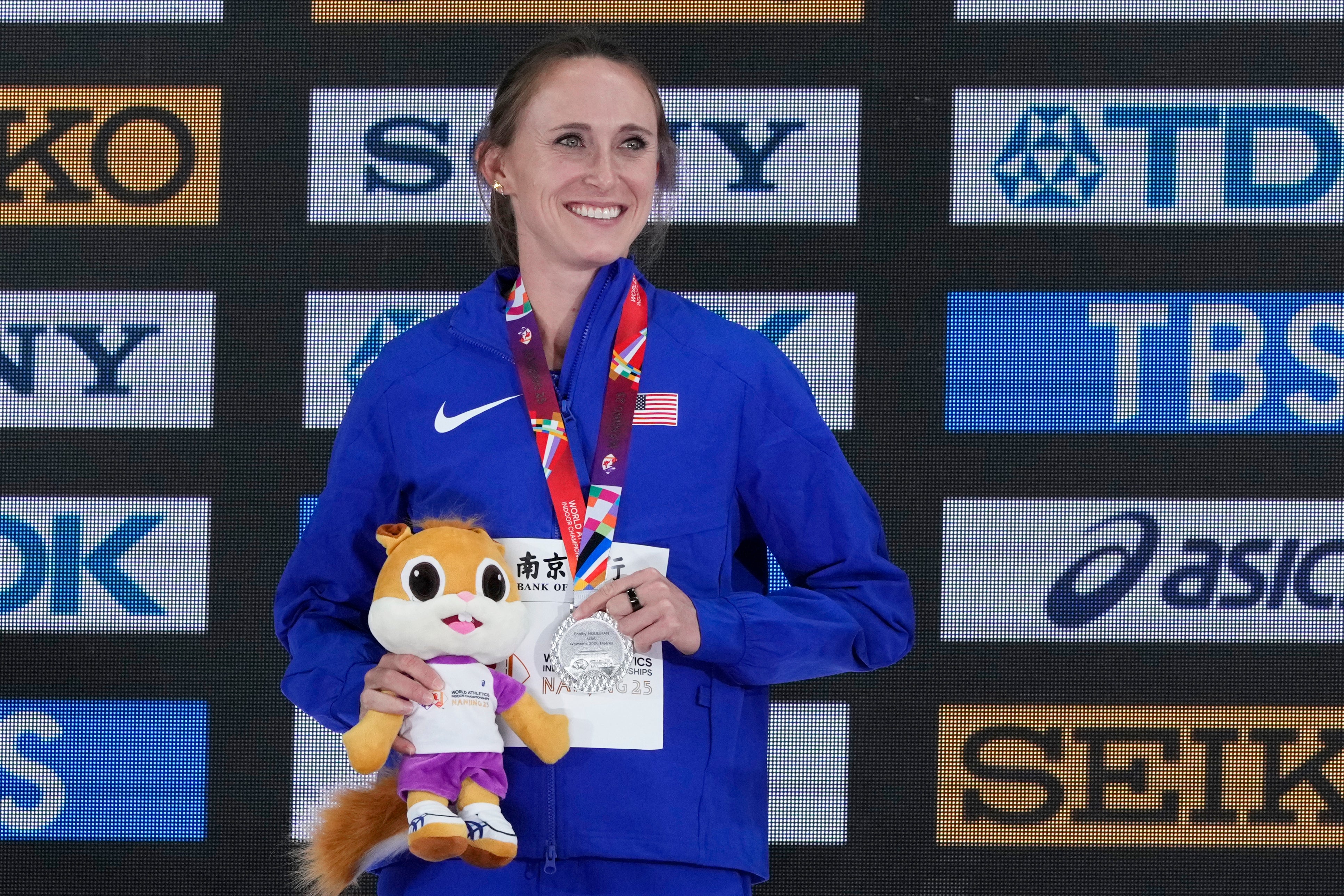 Shelby Houlihan poses on the podium after winning the silver medal in the women's 3000 meters at the World Athletics Indoor Championships in Nanjing, China, March 22, 2025