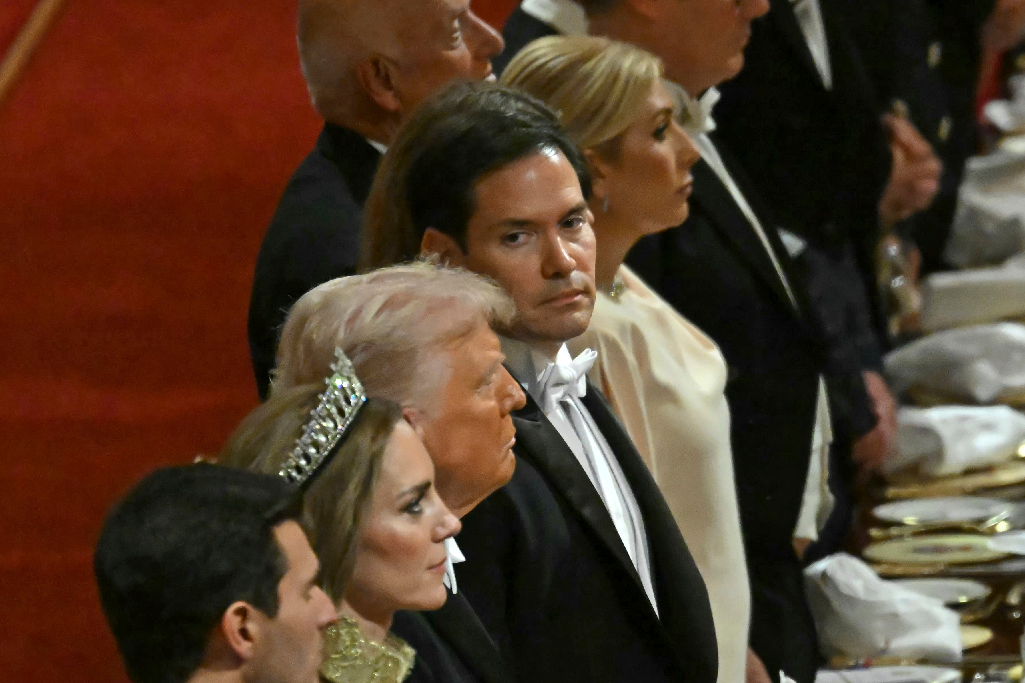 US Secretary of State Marco Rubio looks at President Donald Trump as they attend Wednesday's state banquet