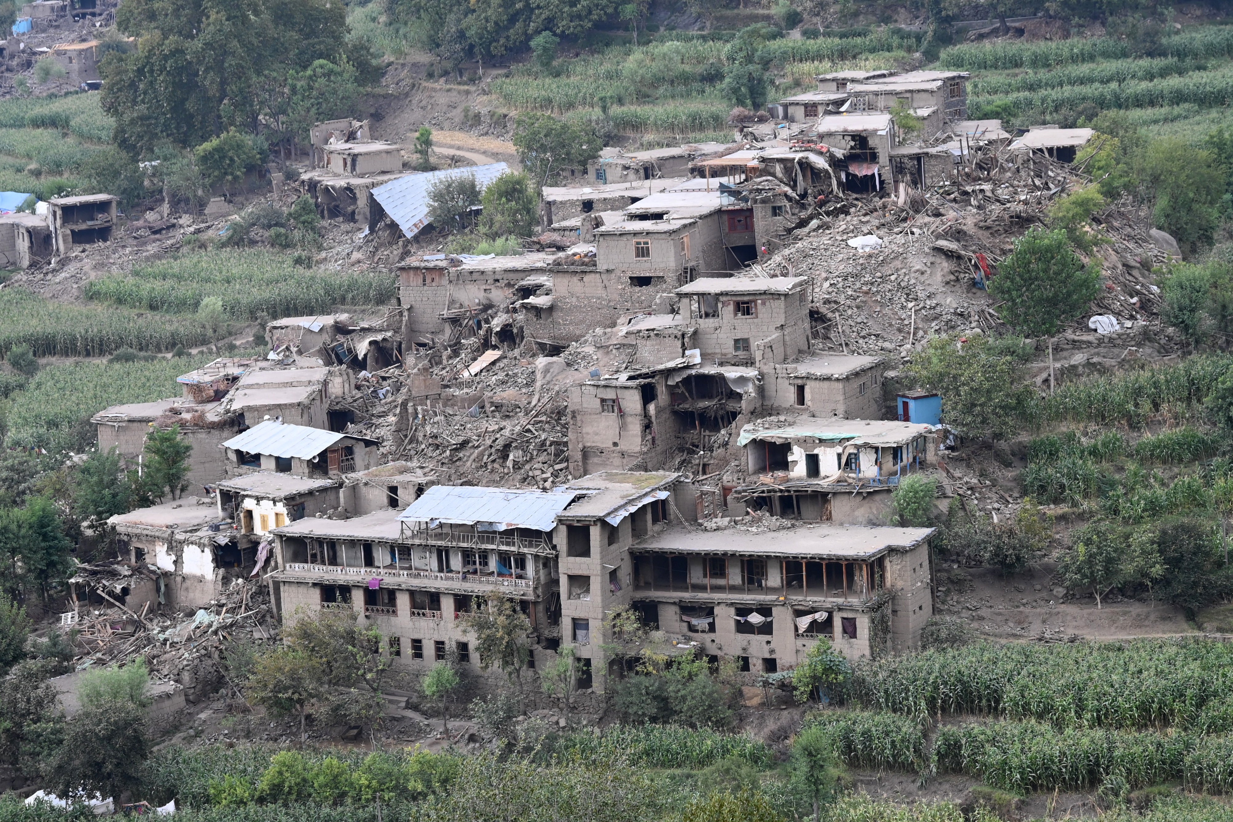 Remains of damaged houses in the aftermath of an earthquake at Mazar Dara village in Nurgal district