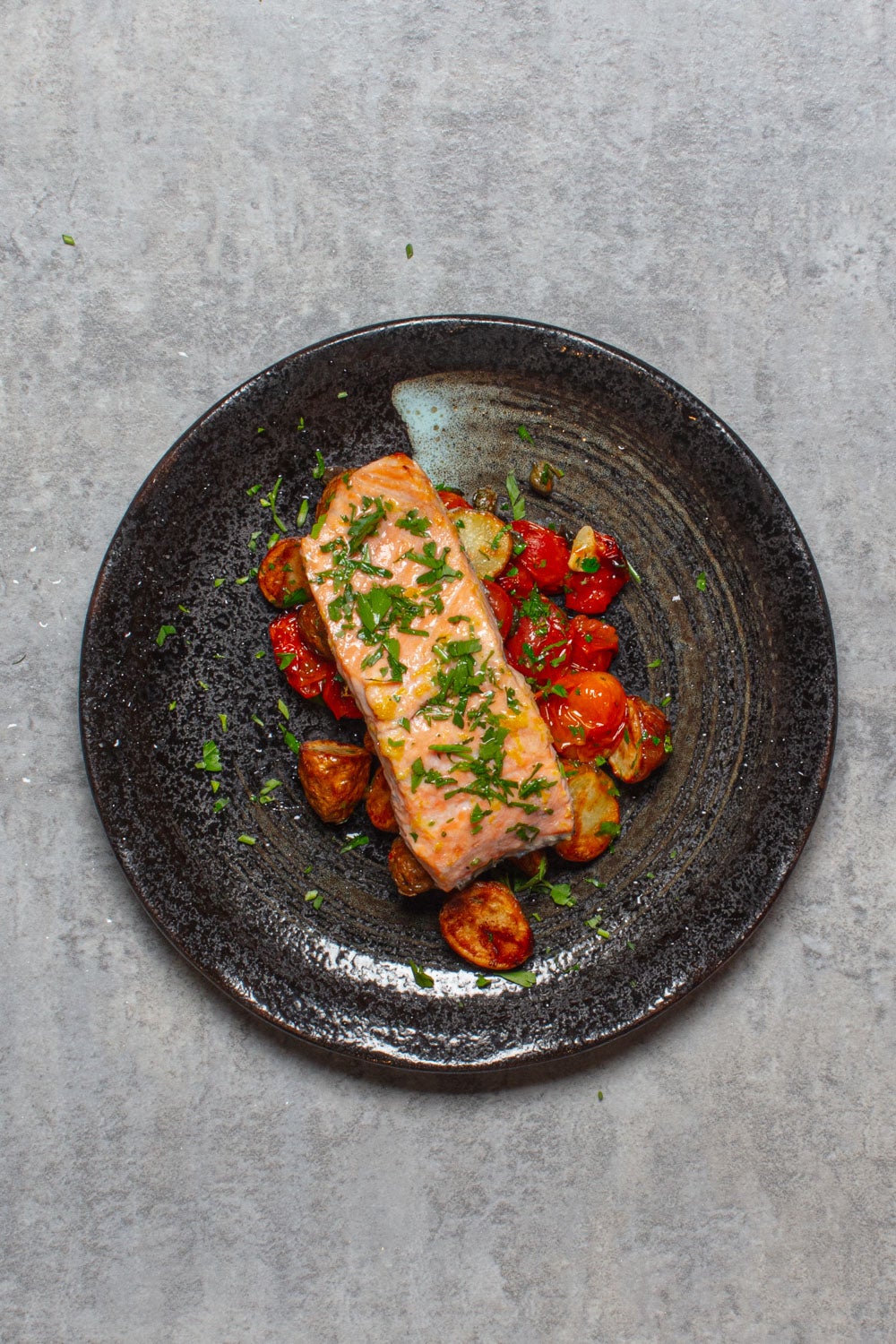 Flaky salmon meets jammy tomatoes and crisp potatoes – a speedy dinner that feels far fancier than the effort it takes