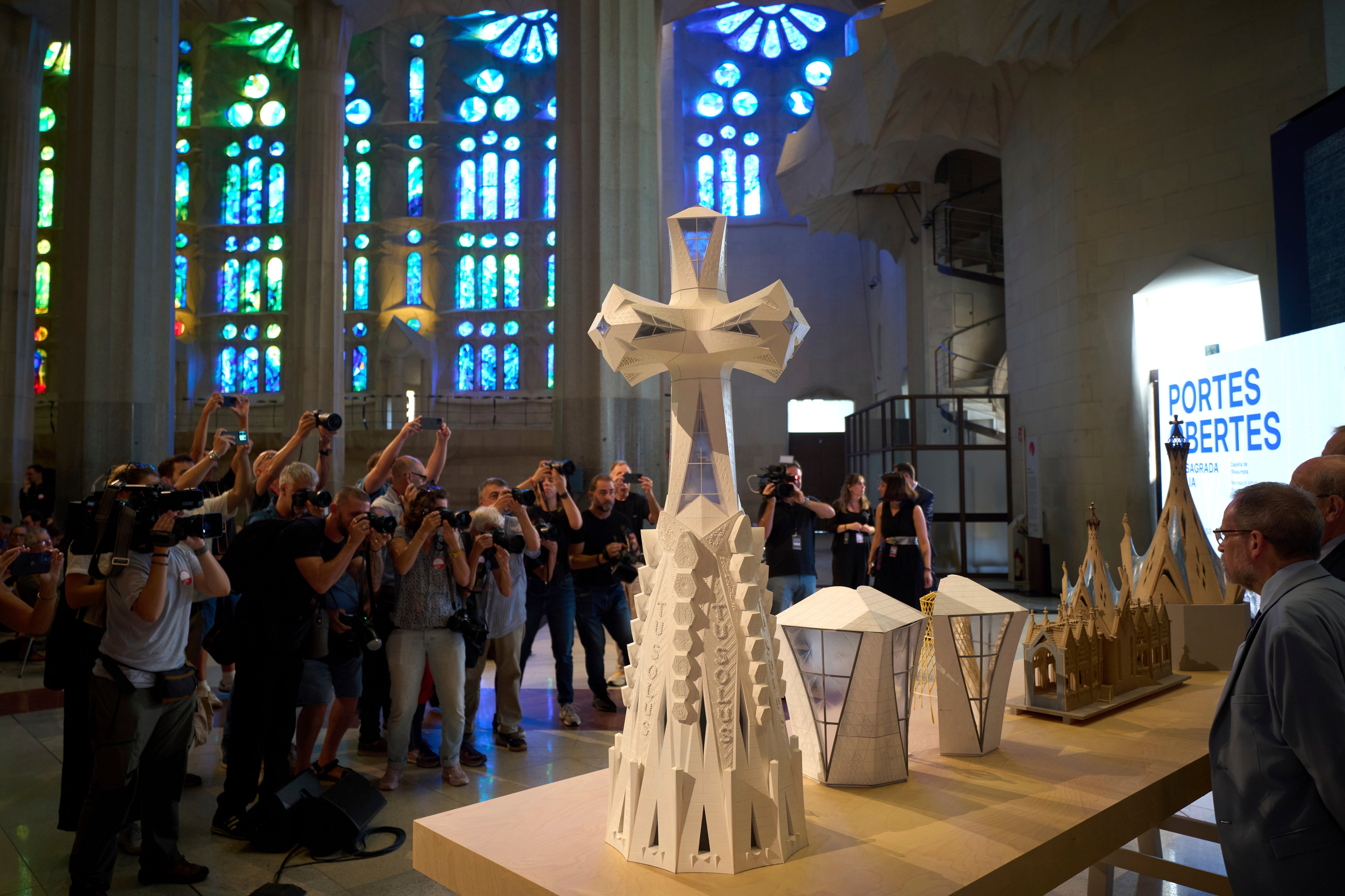 Miniature replicas of the new central tower that will crown the Basilica of the Sagrada Familia, making it the largest Christian church in Europe, are displayed during a press conference in Barcelona, Spain, Thursday, Sept. 18, 2025. (AP Photo/Emilio Morenatti)