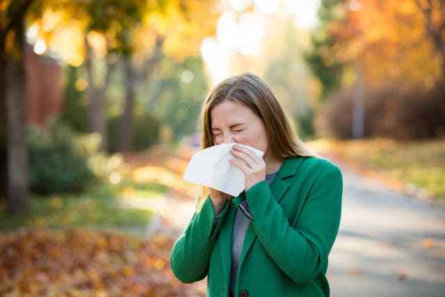 <p>Sick young woman with cold and flu standing outdoors</p>