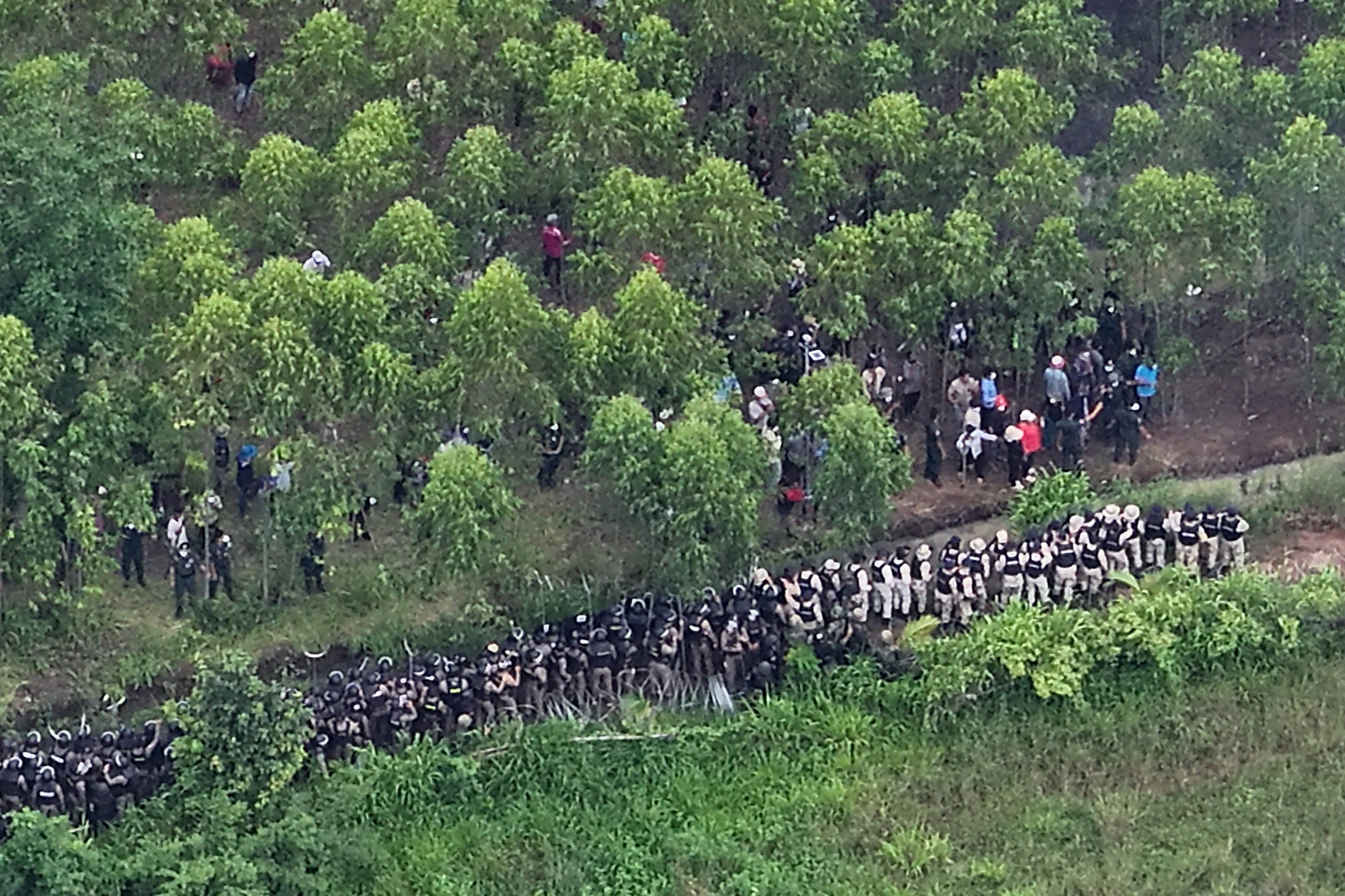 Thai army and police (bottom) facing Cambodian people in a disputed area along the Cambodia-Thailand border, as seen from Sa Kaeo province