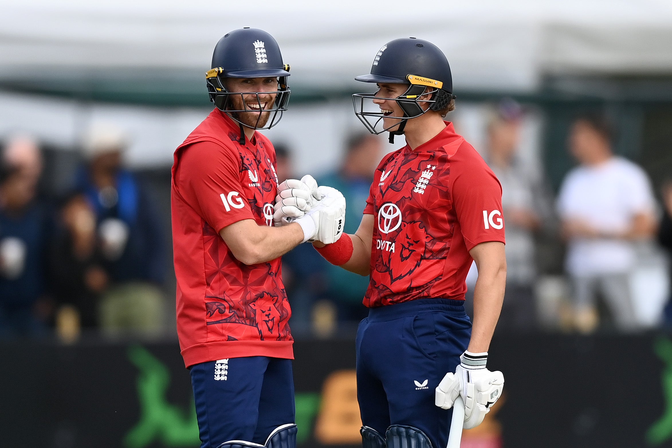 Phil Salt of England celebrates reaching his half century with captain Jacob Bethell during the first T20 International match between Ireland and England