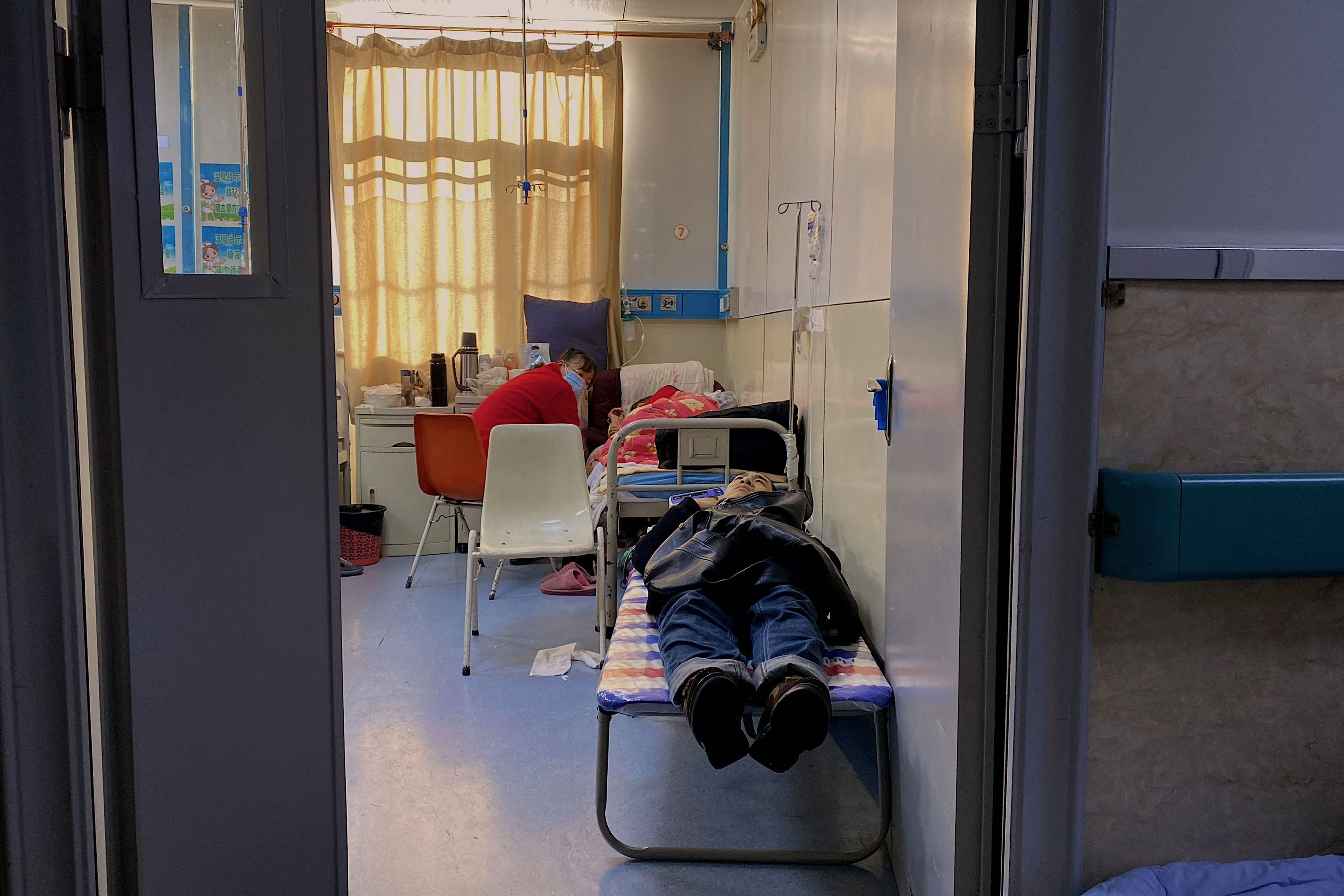 A patient with Covid-19 rests on a bed at Tangshan Gongren Hospital in China's northeastern city of Tangshan
