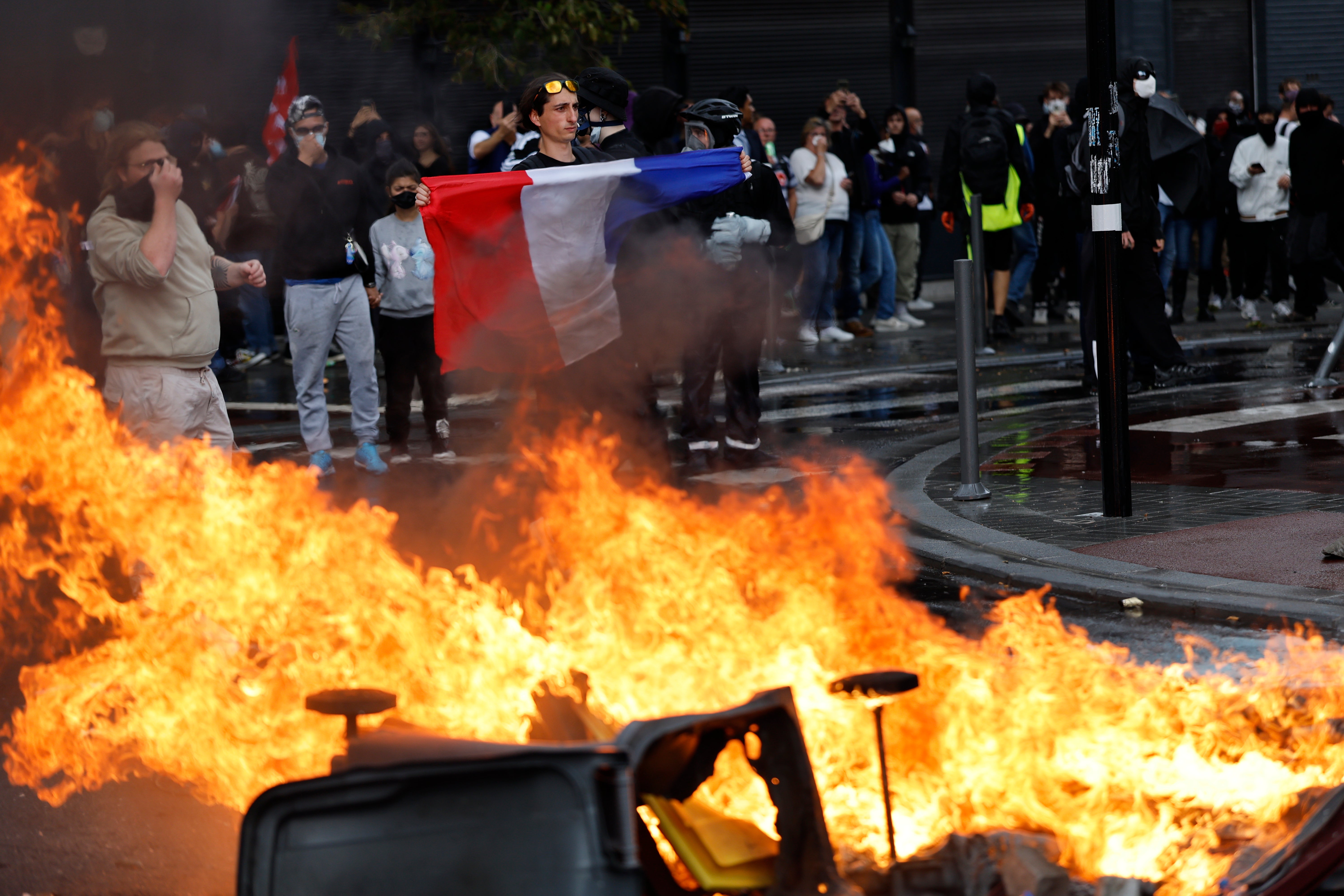Protesters next to a burning bin in Lille, northern France, last week