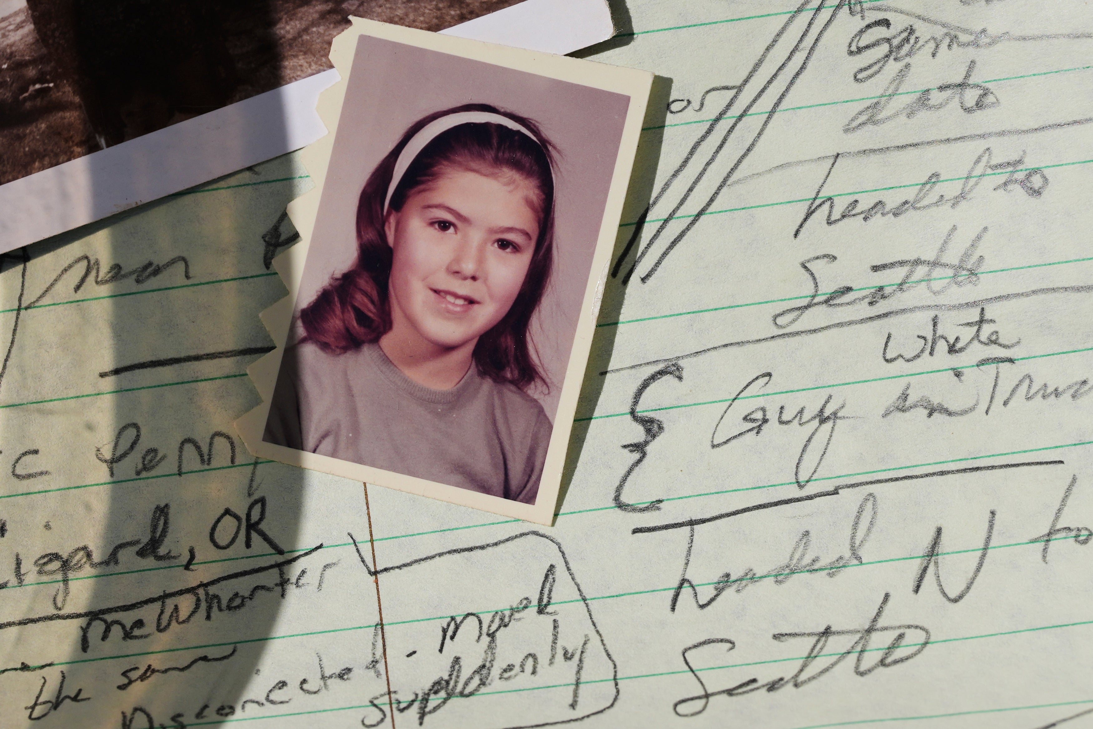 A school photo of Marion Vinetta Nagle McWhorter, who disappeared in 1974 in Oregon and whose remains were recently confirmed by DNA from her sister Valerie Nagle, is seen over notes taken by Nagle about McWhorter's disappearance Thursday, Sept. 18, 2025, in Seattle. (AP Photo/Lindsey Wasson)