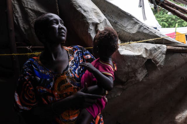 <p>Rebekah Nyekhor, a mother, stands inside her makeshift home in a camp for displaced persons in Sudan</p>