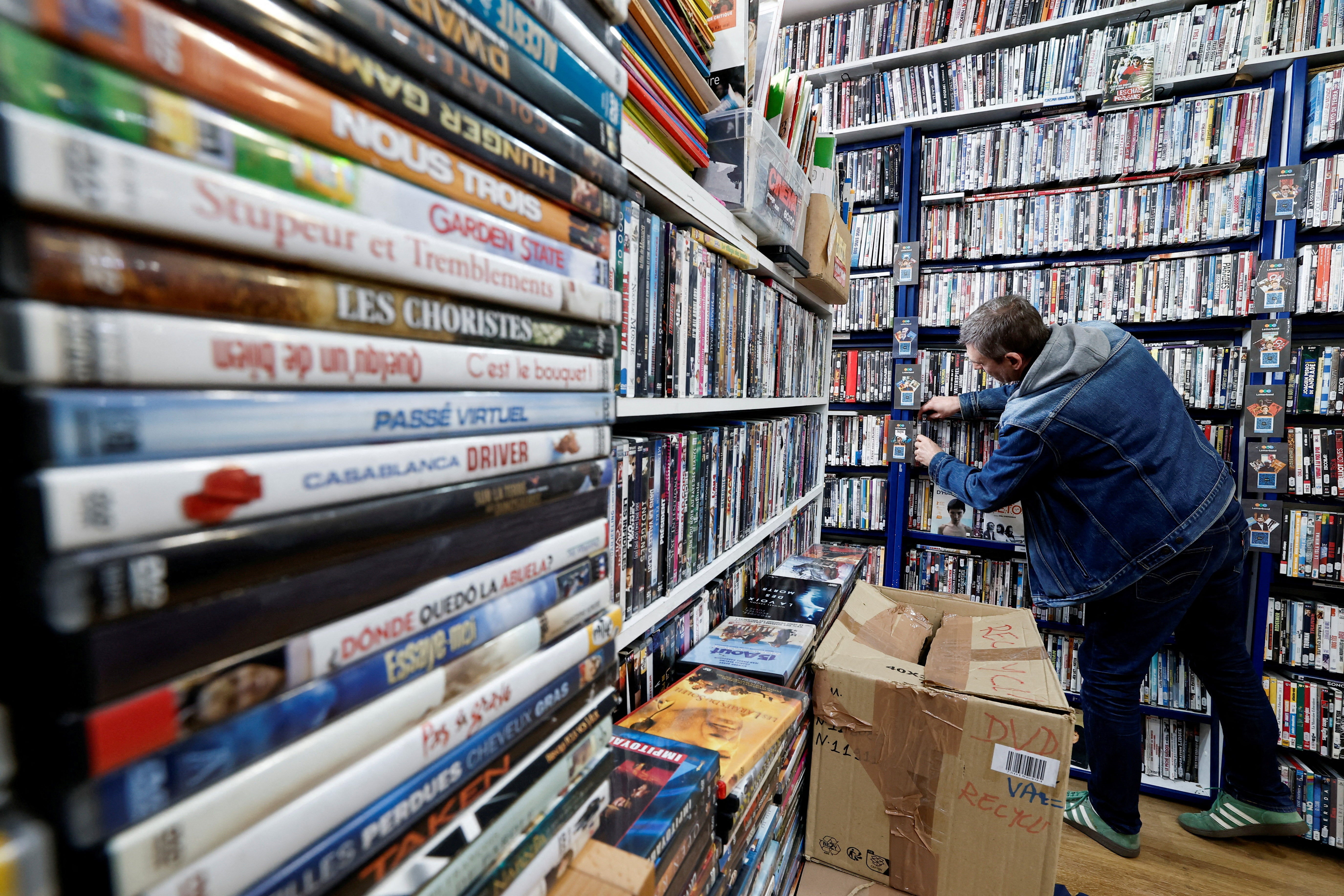 A man browses some DVD releases for rent at JM Video