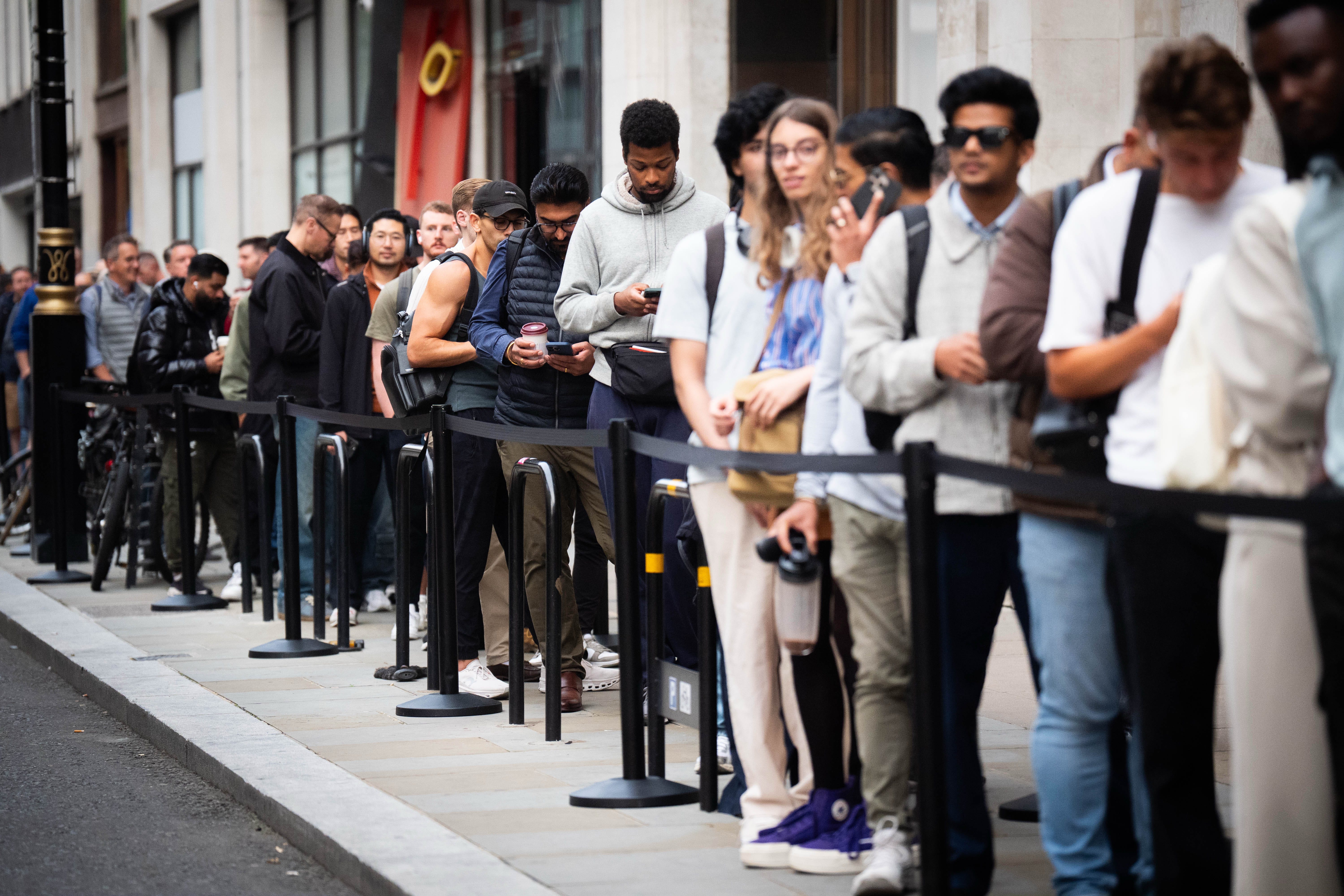 Customers queue to buy the new Apple iPhone 17 outside the tech giant’s flagship store in Regent Street, central London. Picture date: Friday September 19, 2025.