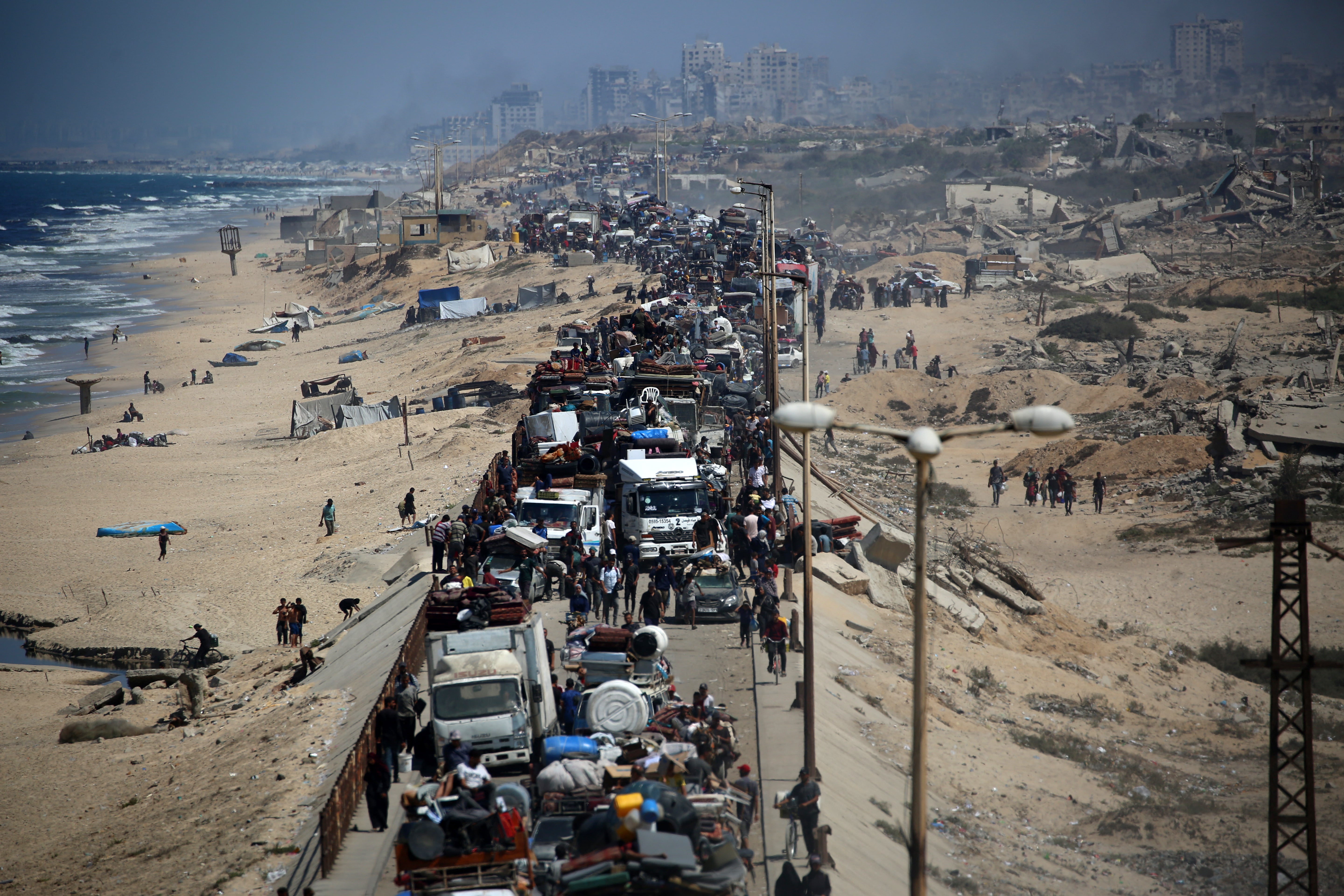 Palestinians from Gaza City move southwards with their belongings, on the coastal road near the Nuseirat refugee camp in the central Gaza Strip, on September 19, as Israel’s relentless bombardment continues