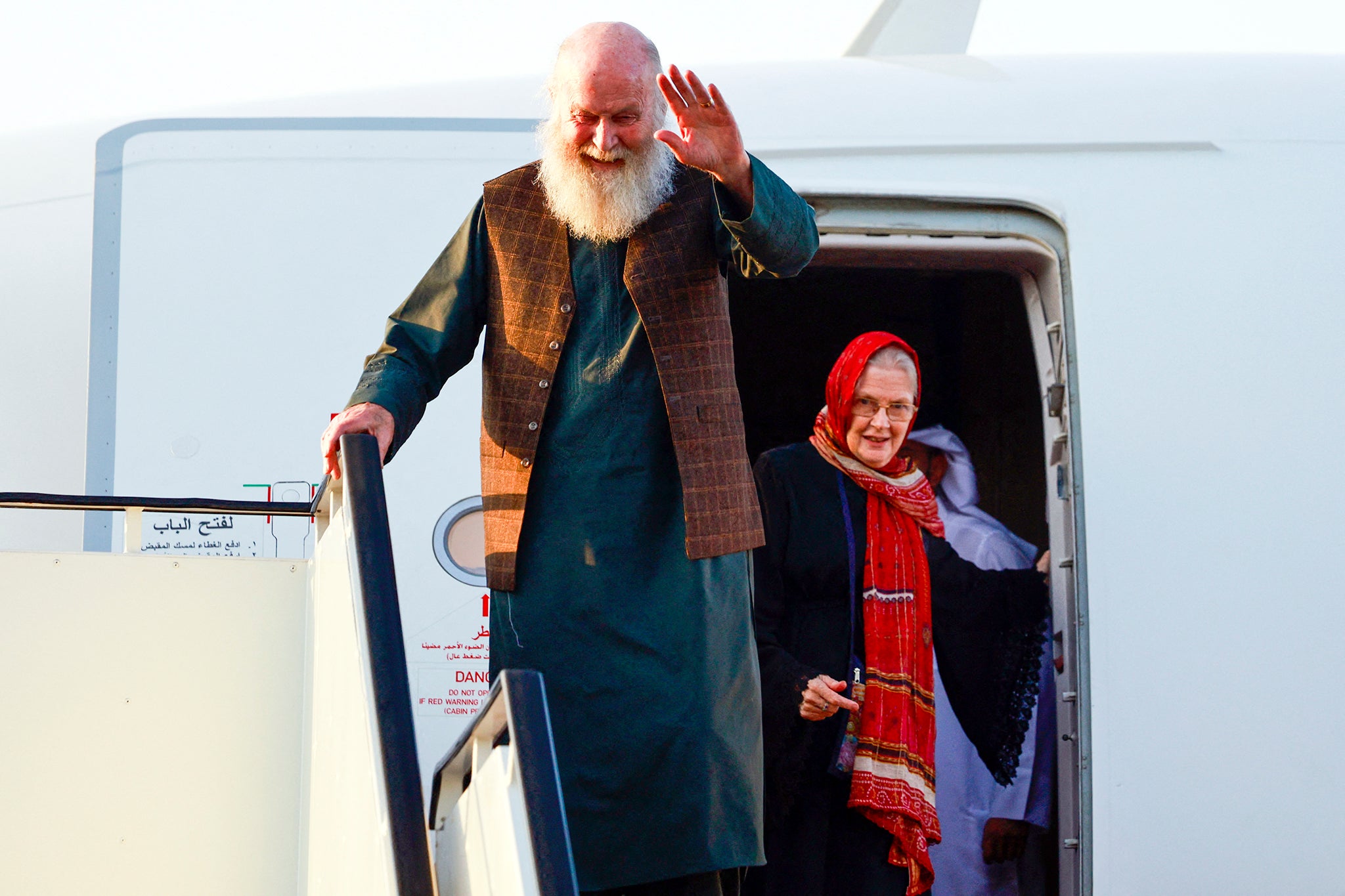 Peter and Barbie Reynolds disembark after landing at the airport in Doha