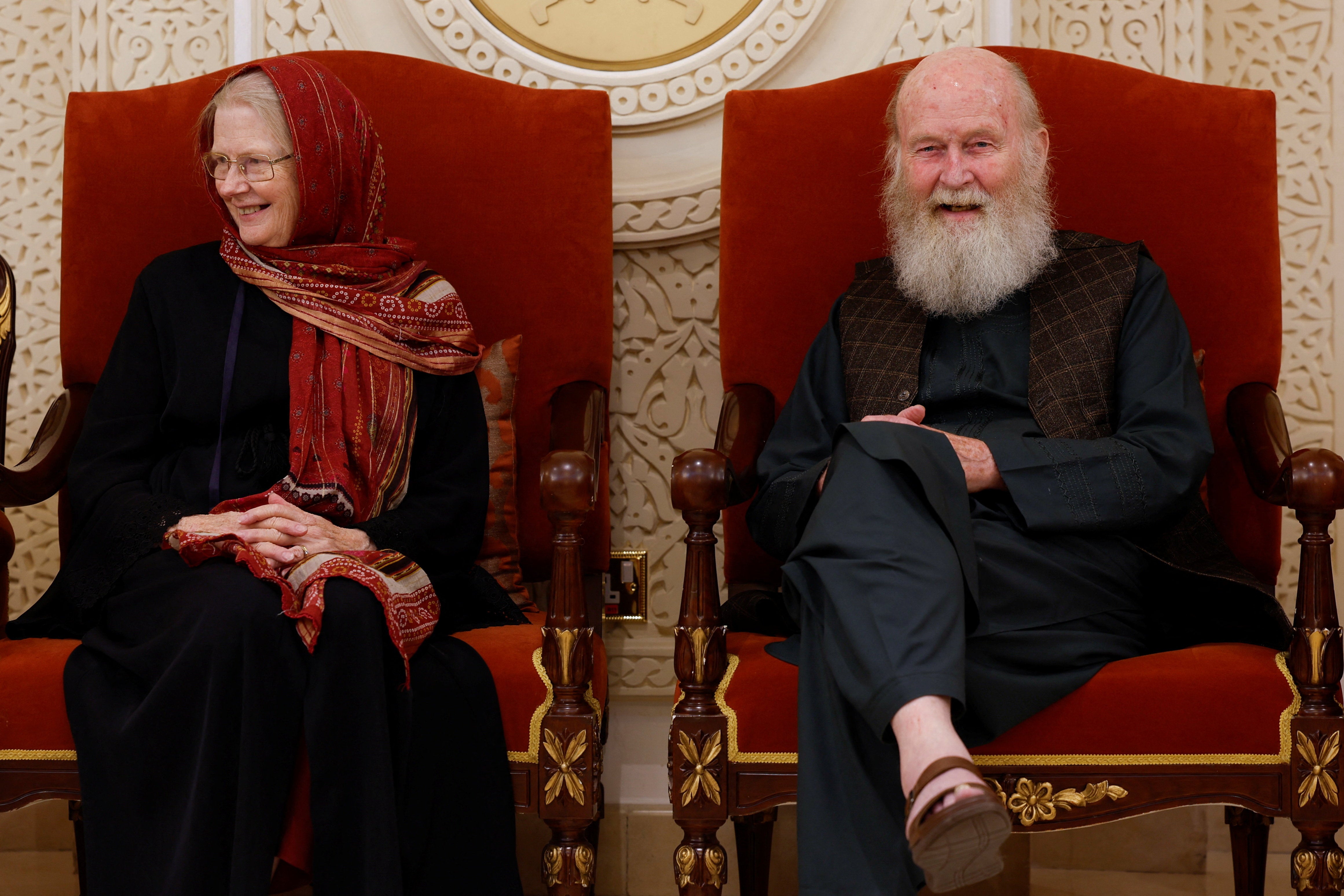 British couple Peter and Barbie Reynolds rest after disembarking from a plane in Doha, Qatar, last week following their release