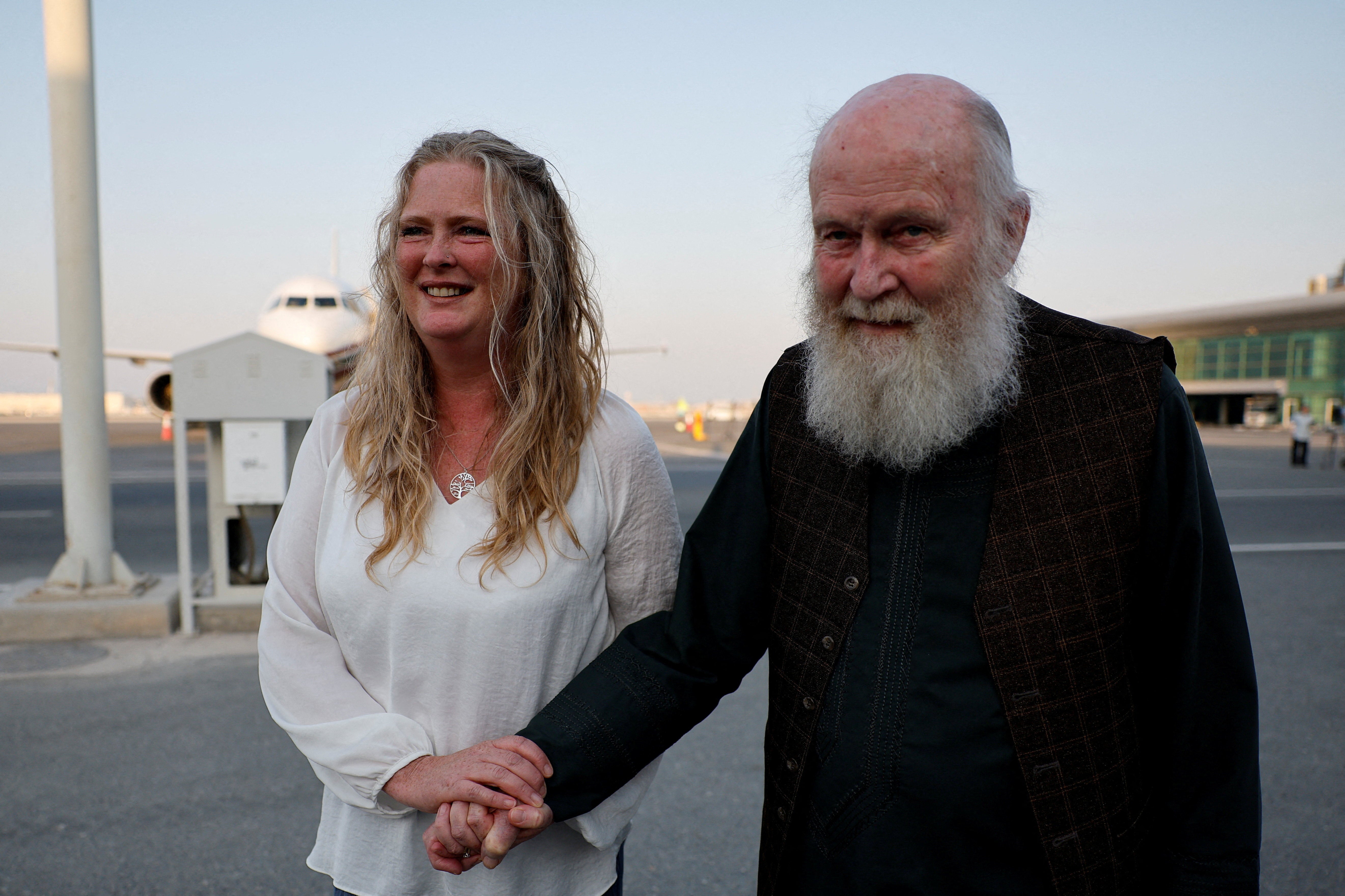 Peter Reynolds walks with his daughter Sarah Entwistle after disembarking from a plane in Doha, Qatar, last week