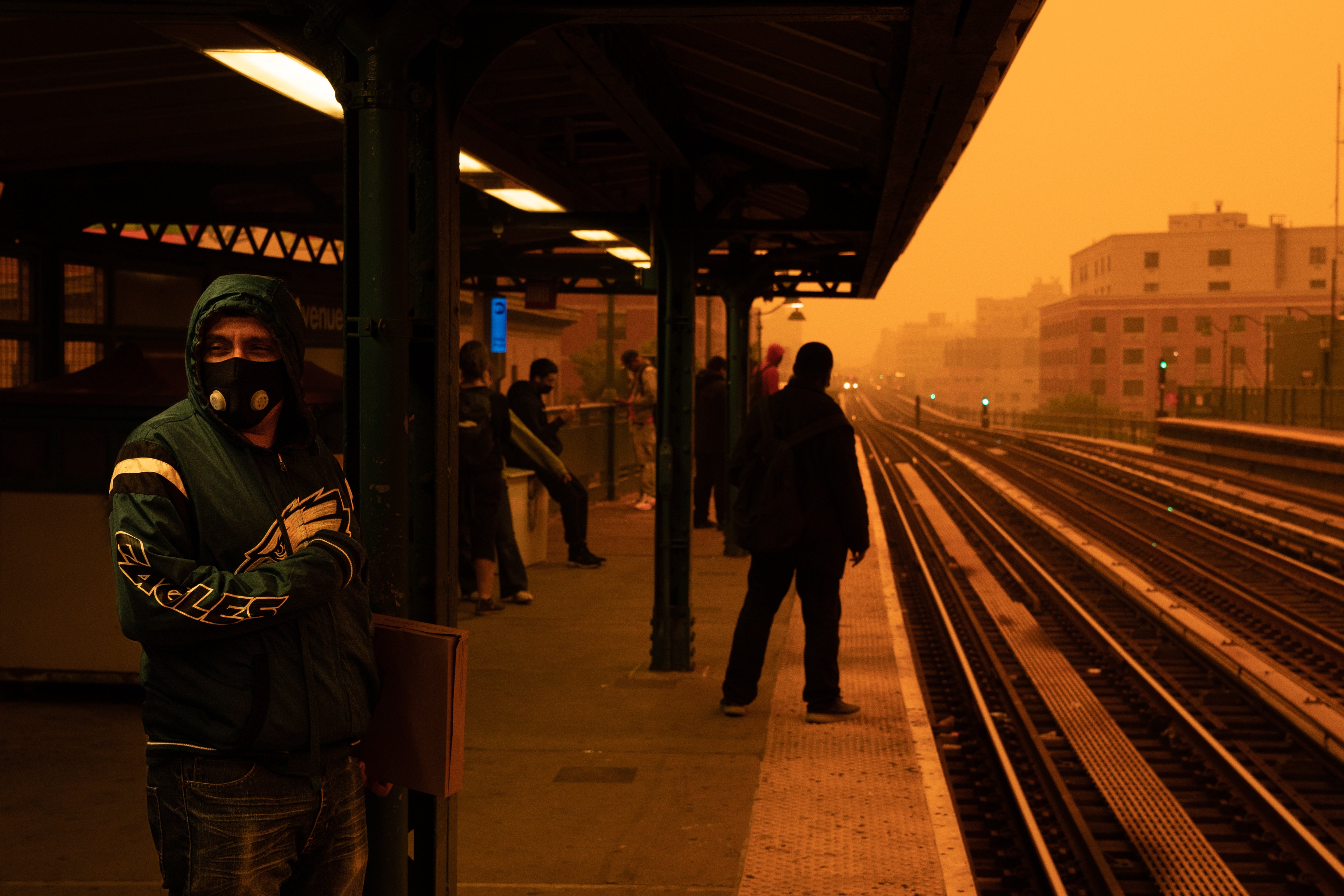A person waiting for the subway wears a filtered mask as smoky haze from wildfires in Canada blankets a neighborhood on June 7, 2023 in the Bronx borough of New York City. Wildfire smoke is already killing roughly 40,000 Americans each year, according to new research