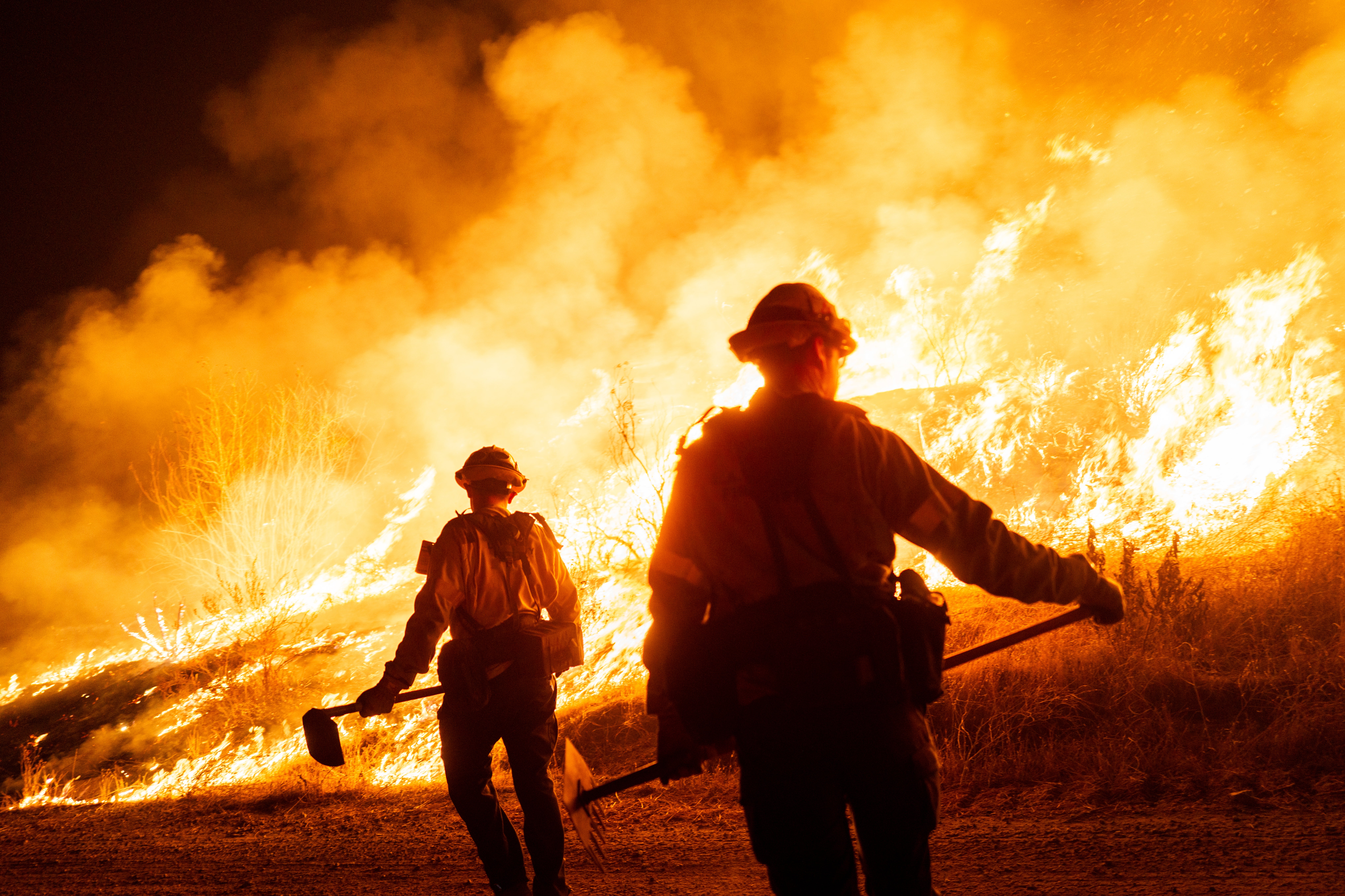 Firefighters work as the Hughes Fire burns on January 22, 2025 in Castaic, California. Exposure to wildfire smoke can lead to an increased risk of heart attacks and worsened respiratory health