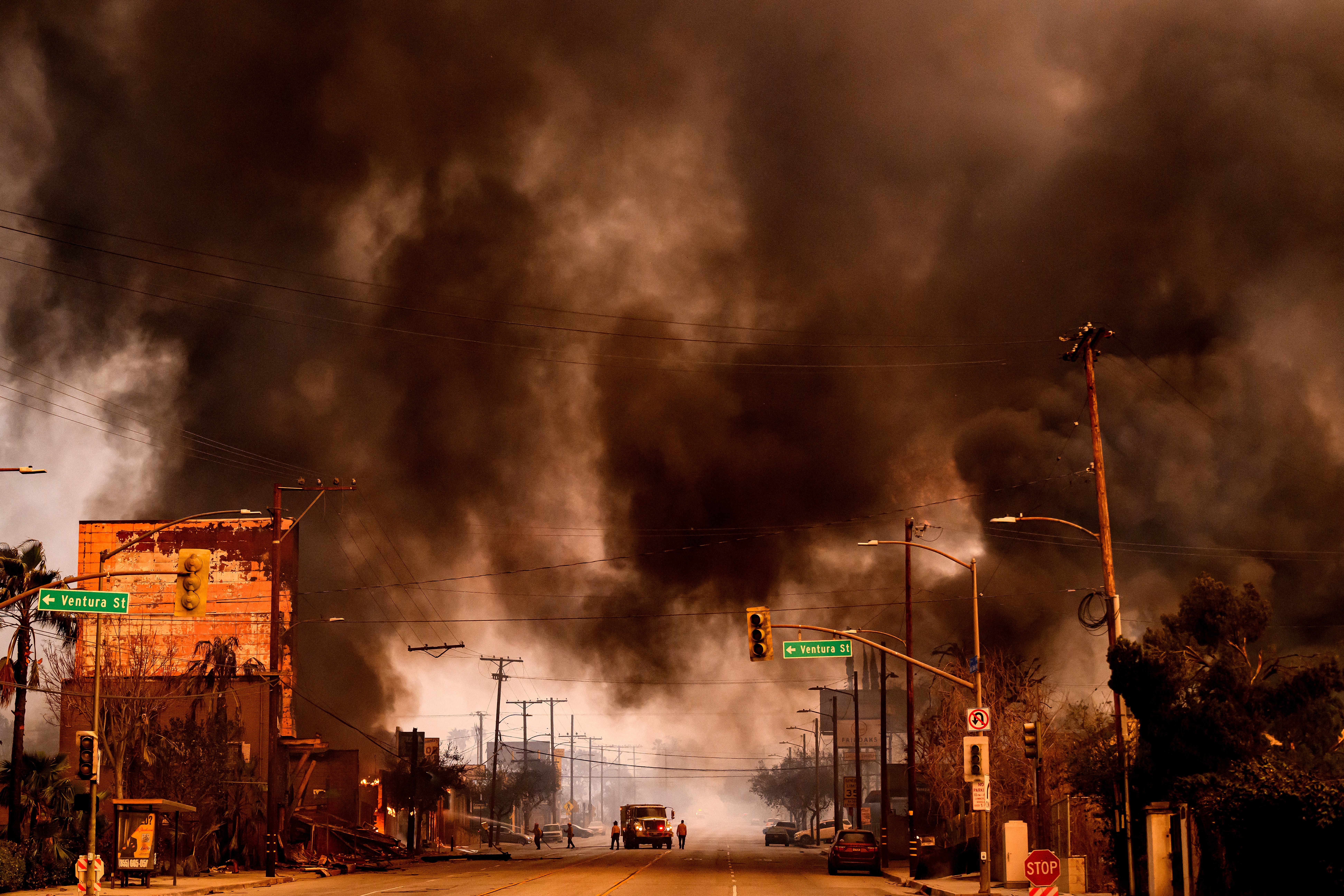 Smokes and flames overwhelms a commercial area during the Eaton fire in the Altadena area of Los Angeles County, California on January 8, 2025. Wildfires are becoming increasingly intense and frequent, producing dangerous smoke that can travel thousands of miles