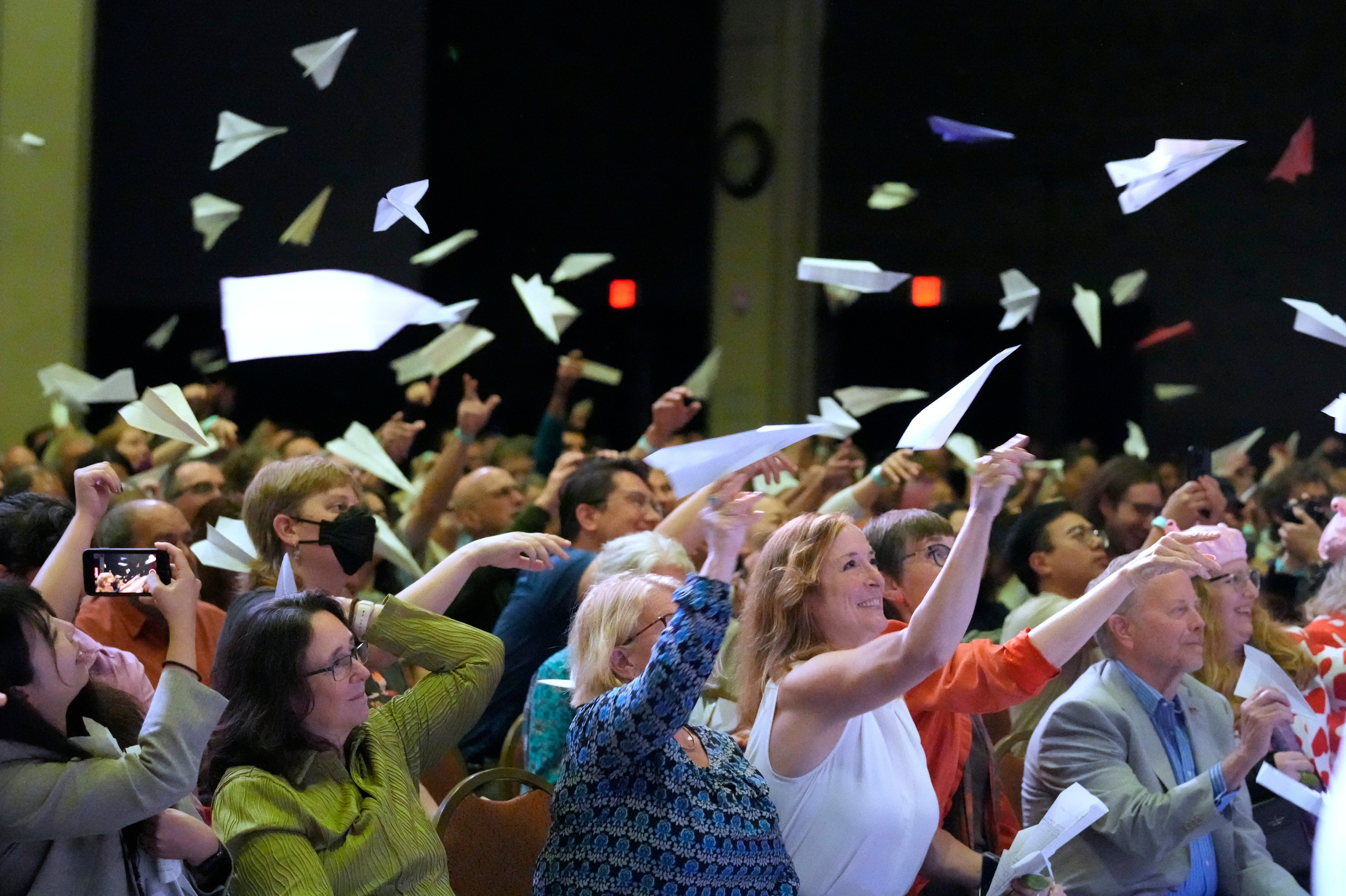 Audience members toss paper airplanes during the Ig Nobel Prize award ceremony
