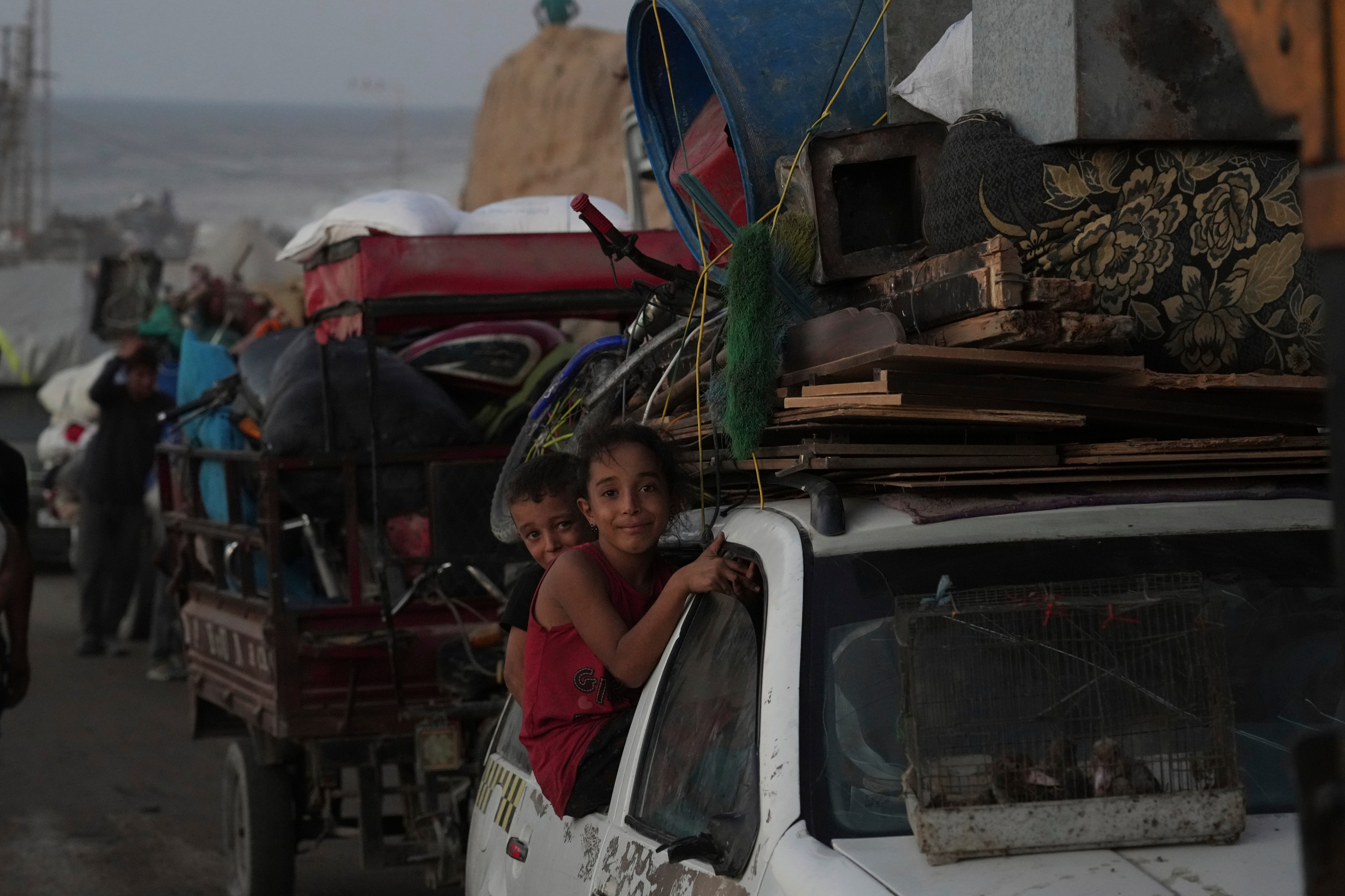 Displaced Palestinians flee Gaza City, carrying their belongings along the coastal road in Nuseirat toward the southern Gaza Strip, Friday, Sept. 19, 2025. (AP Photo/Abdel Kareem Hana)