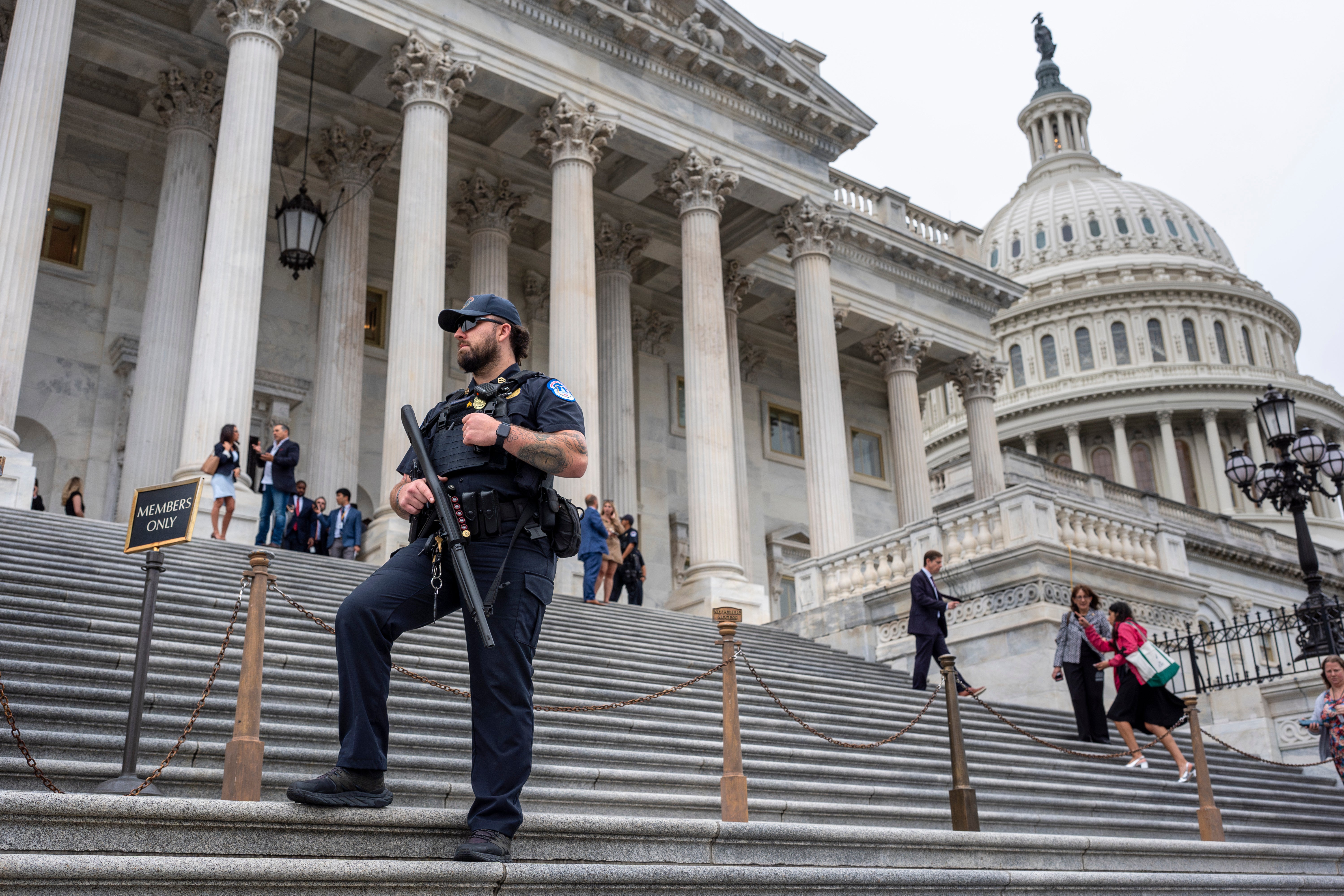 U.S. Capitol Police officer stands watch as lawmakers leave the House of Representatives