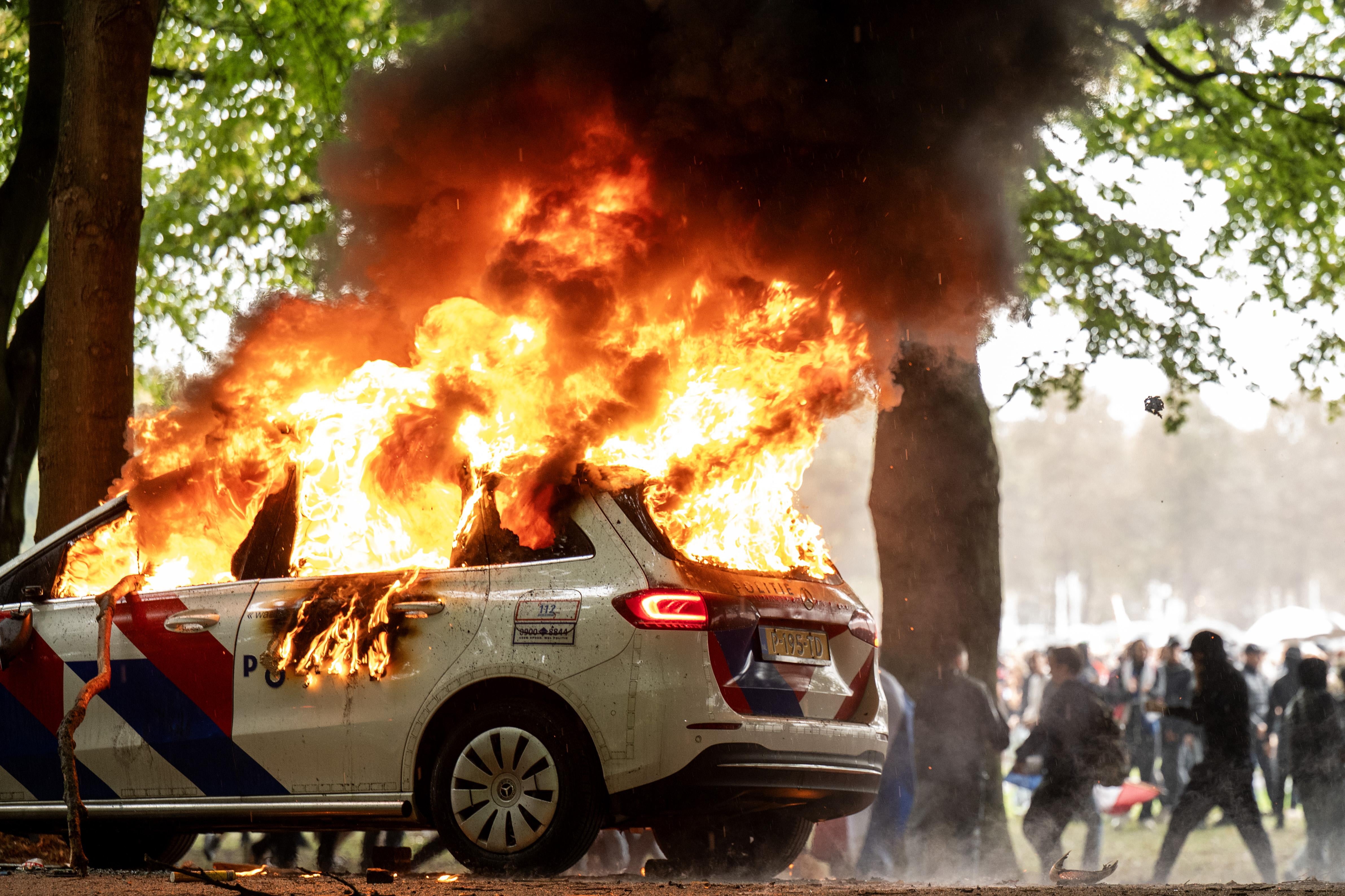 A police car is set on fire during a protest against the current asylum policy on the Malieveld, in the Hague, the Netherlands, 20 September 2025
