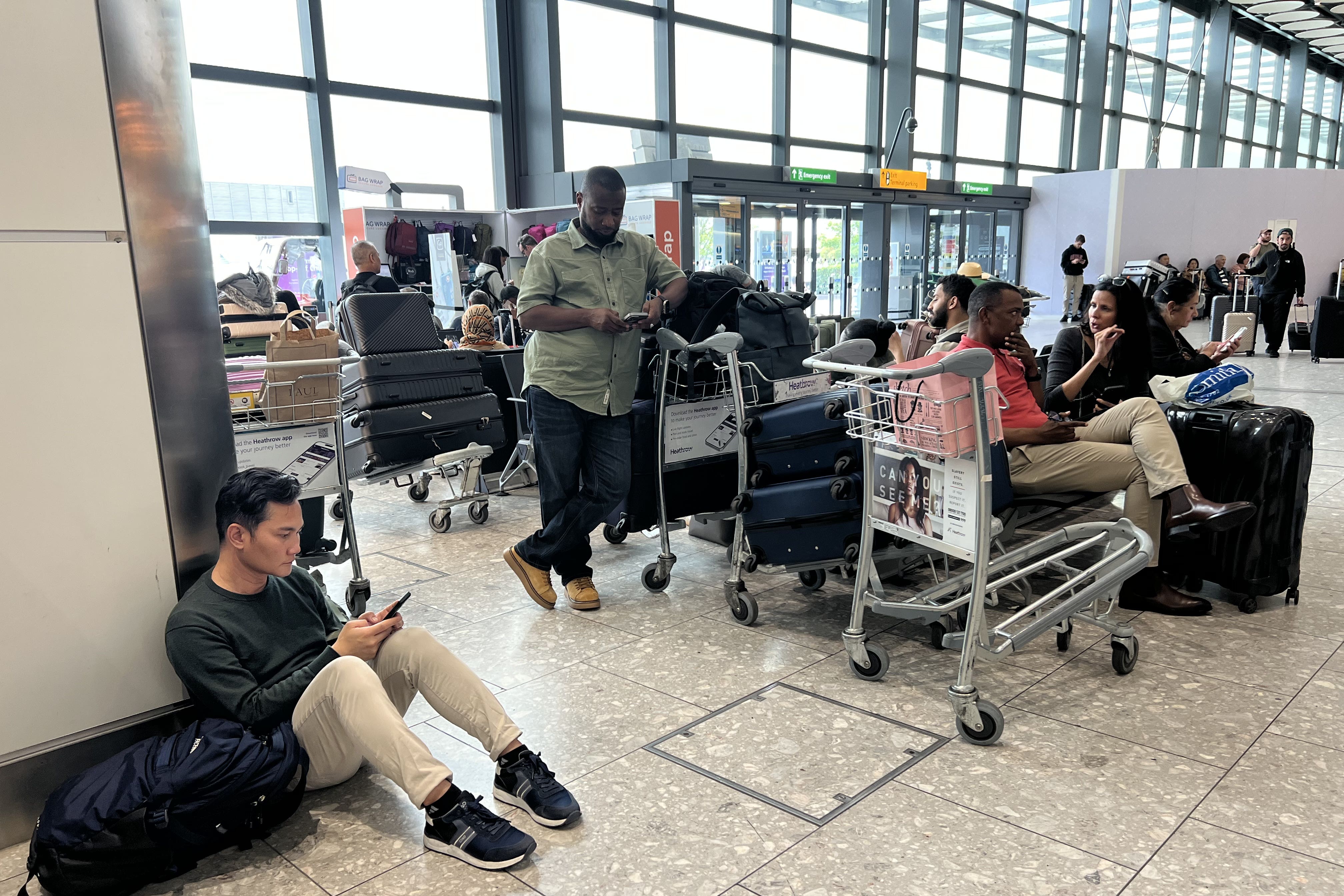 People at T4 at Heathrow Airport after flights were delayed and cancelled at airports including Heathrow after an alleged cyber attack targeted a service provider for check-in and boarding systems (Maja Smiejkowska/PA)