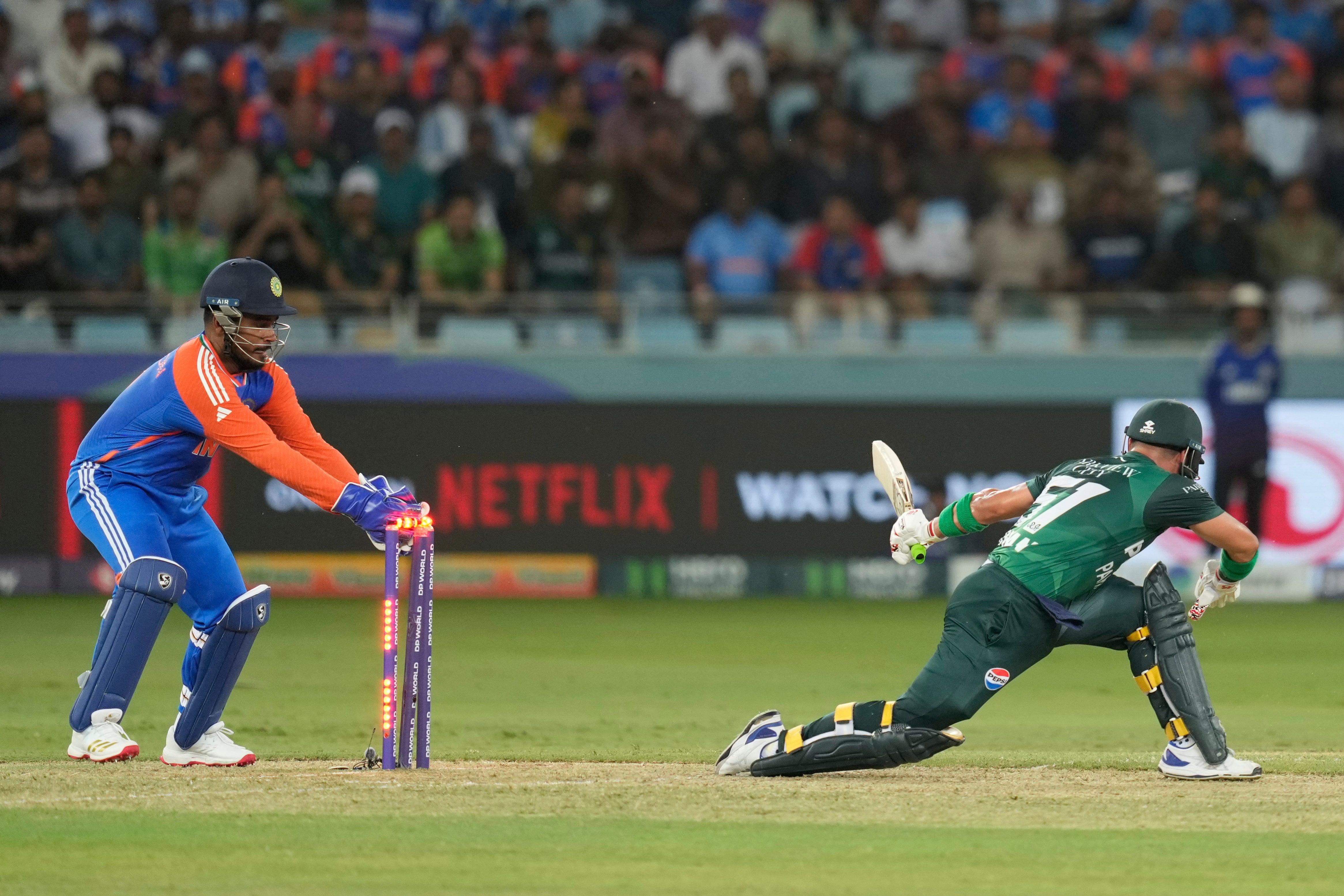 India's Sanju Samson, left, attempts unsuccessfully to stump Pakistan's Sahibzada Farhan during the Asia Cup cricket match between India and Pakistan at Dubai International Cricket Stadium in Dubai, United Arab Emirates, Sunday, 21 September 2025