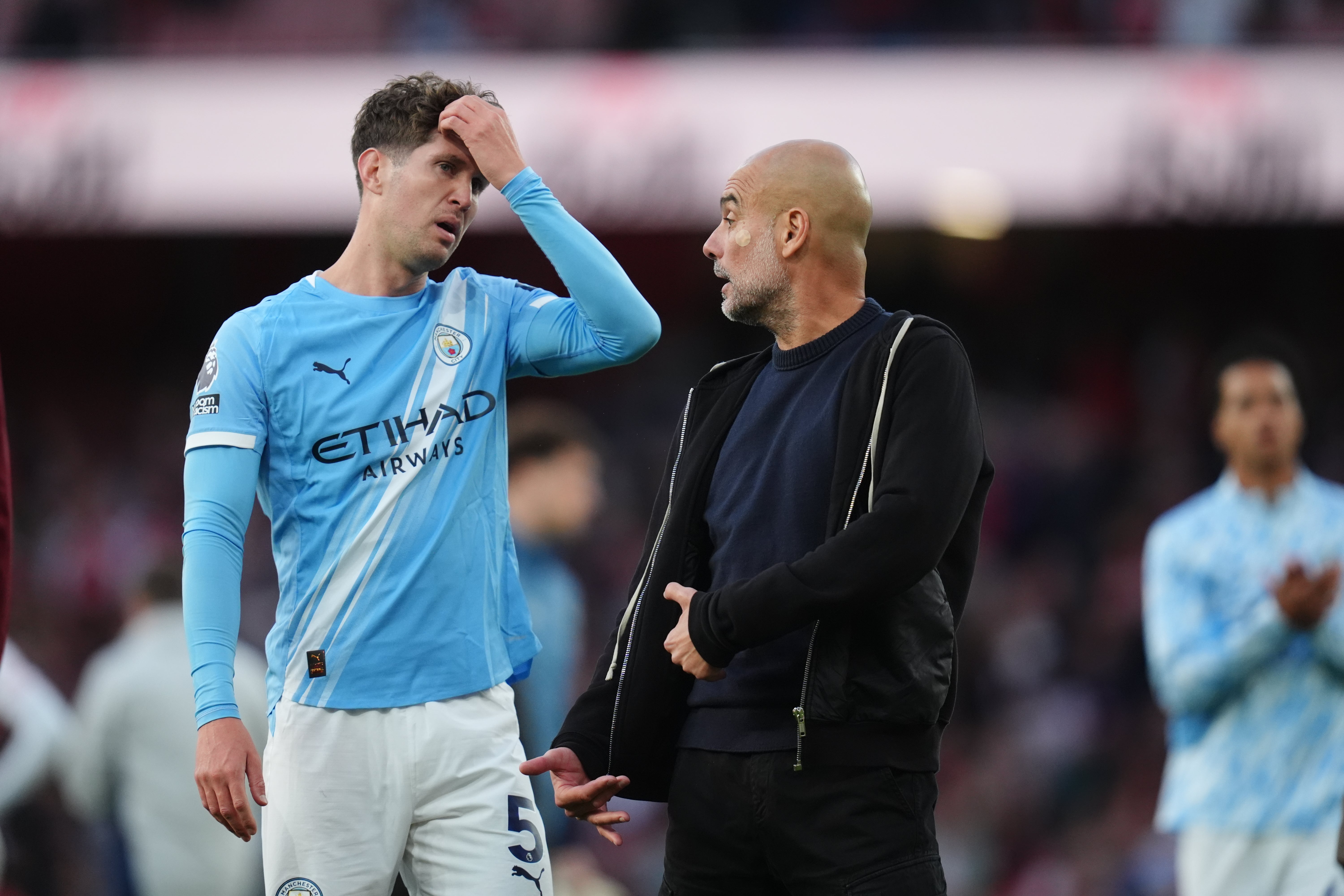 Pep Guardiola in discussion with John Stones at full time