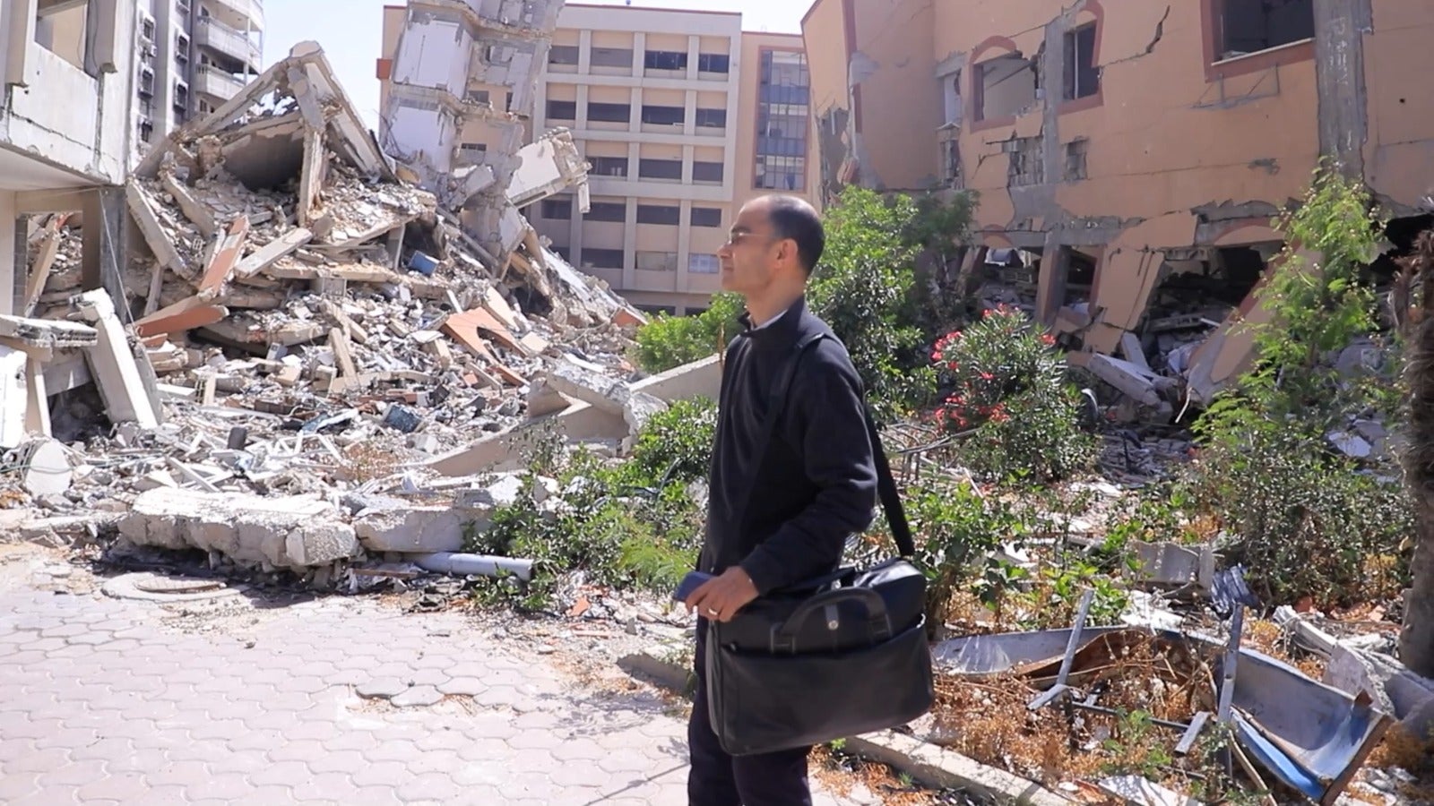 Ahmed Kamal Junina stands in front of what had been his office at Al Aqsa University: ‘This is what the start of the academic year has become in Gaza: education reduced to fragments’