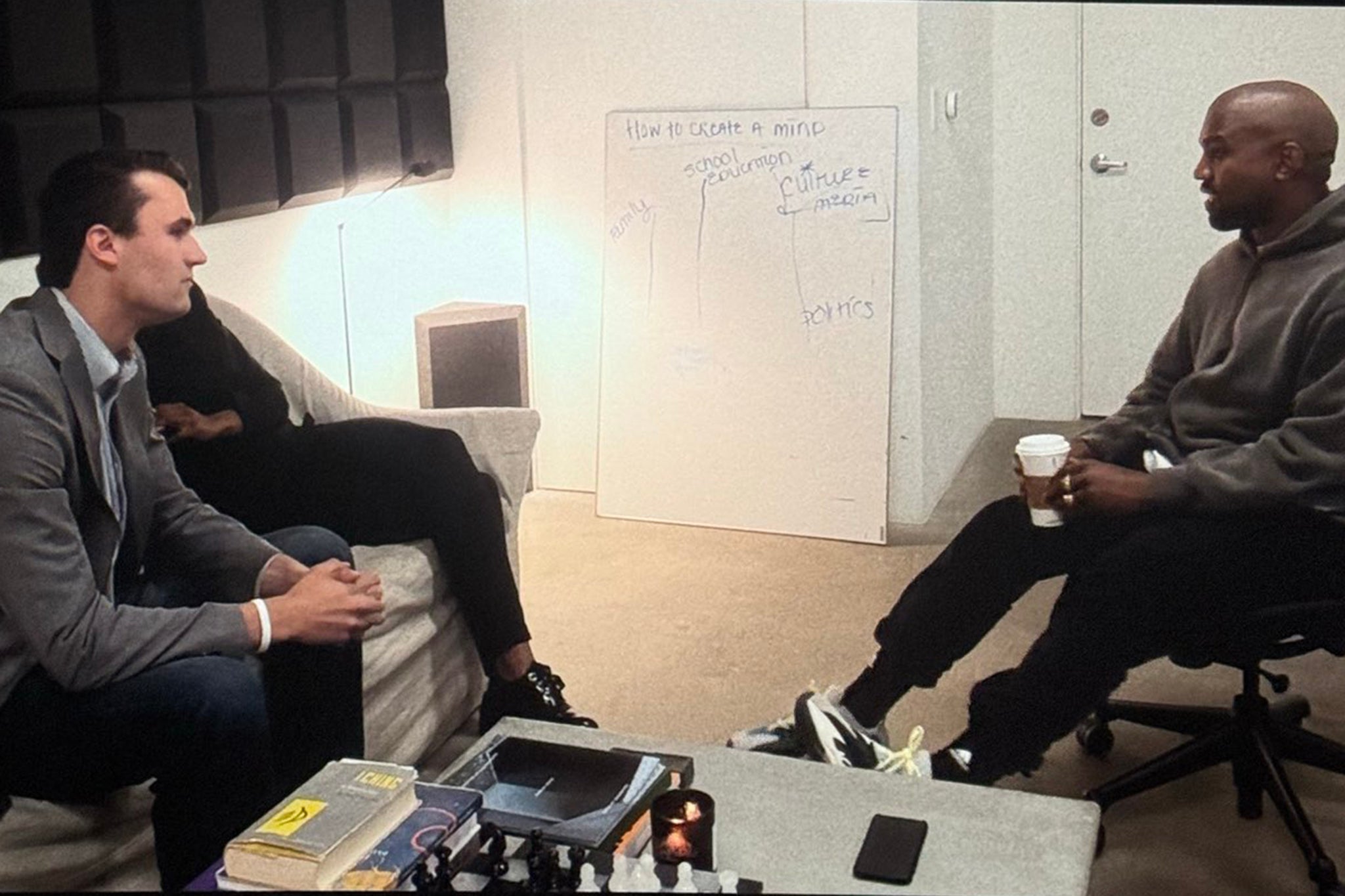 Charlie Kirk and Candace Owens meeting with Kanye West in a scene from ‘In Whose Name?’