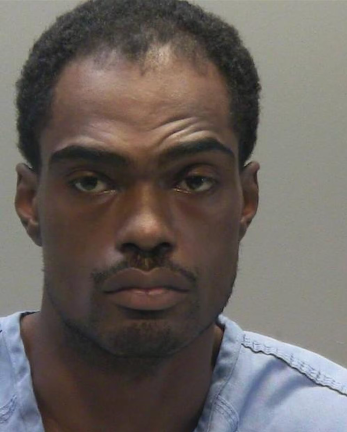 Travis Jackson, 36, was arrested and charged with two counts of murder, two counts of felonious assault and discharging a firearm