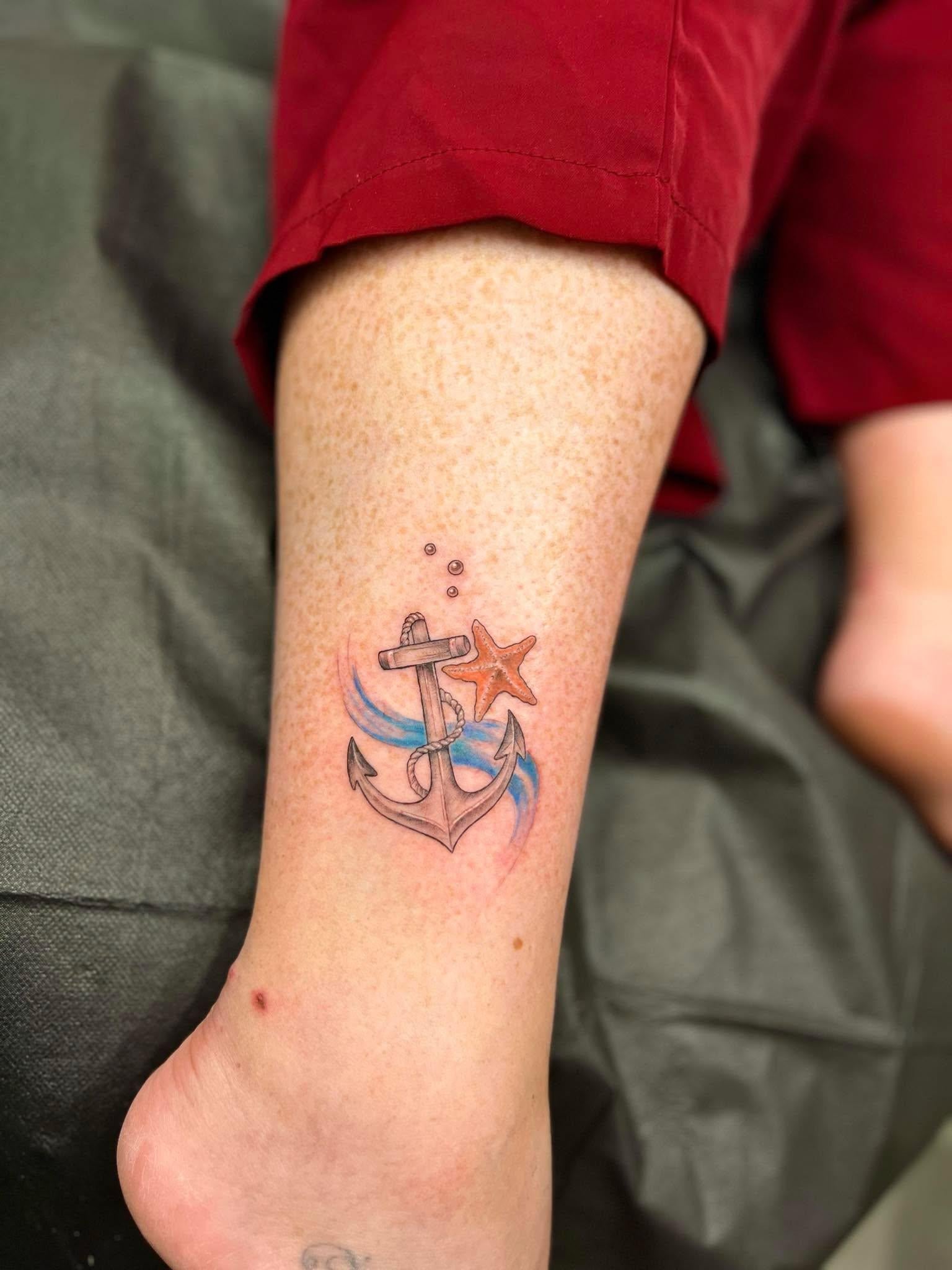 Natalie shows off her fresh Virgin Voyages tattoo