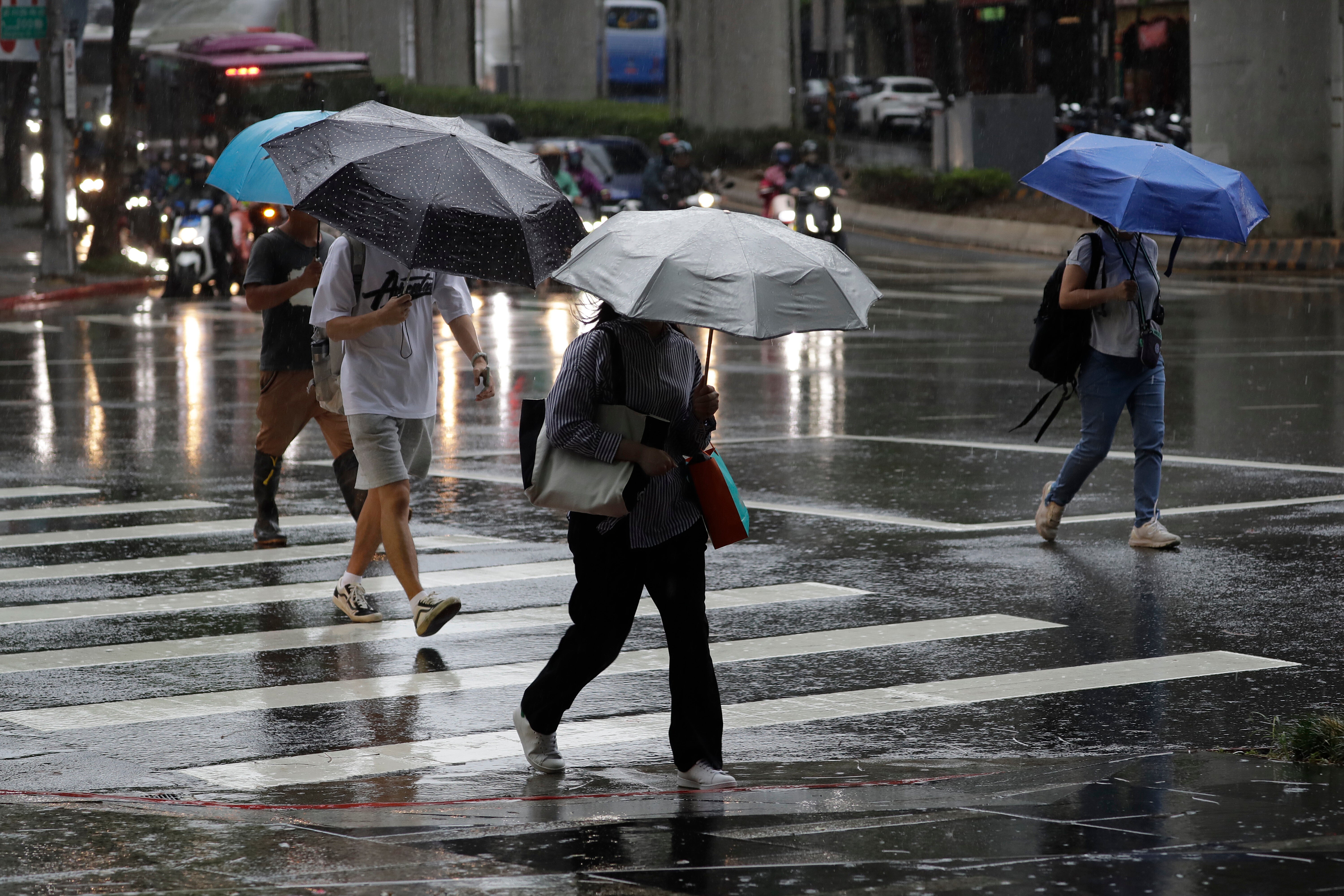 People walk in the rain caused by Ragasa in Taipei, Taiwan