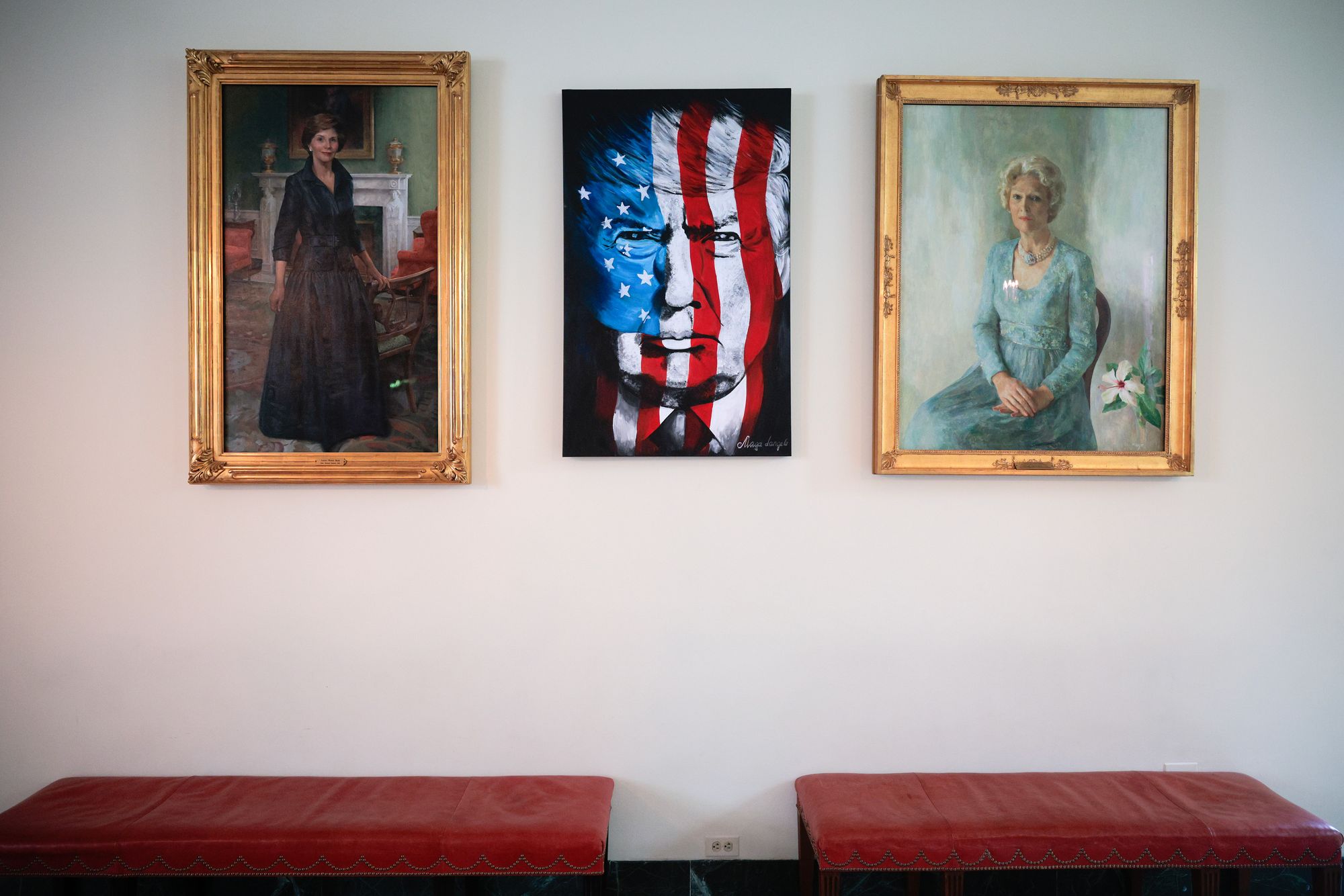 A portrait of Trump, created by a fan, hangs in between two portraits of former first ladies Laura Bush and Patricia Nixon. The Trump painting replaced Hillary Clinton’s portrait