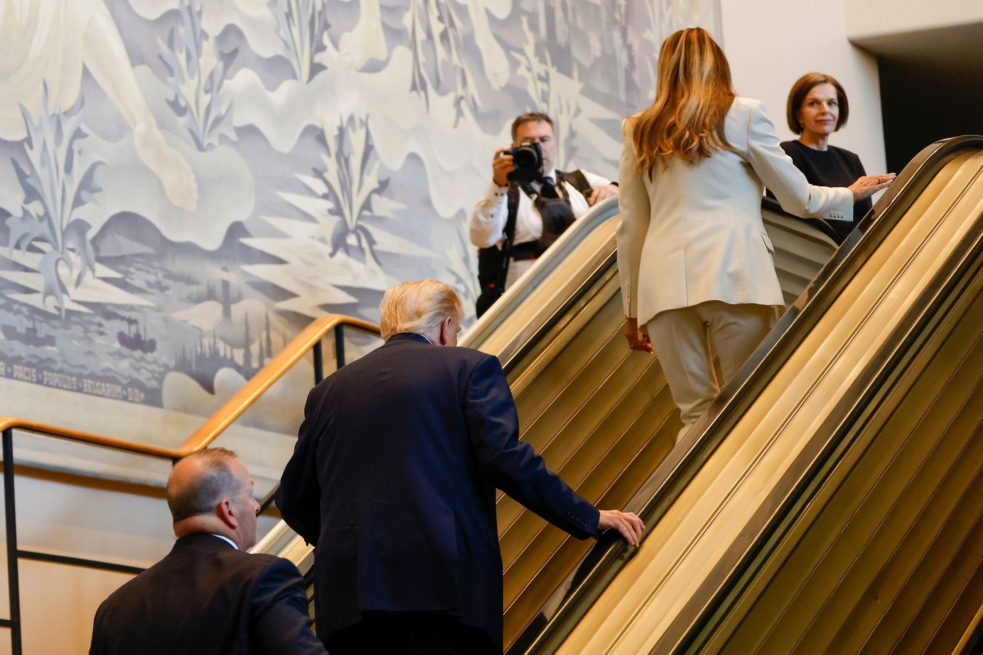 The president and First Lady walked up the steps of the escalator at the UN after it came to an abrupt halt
