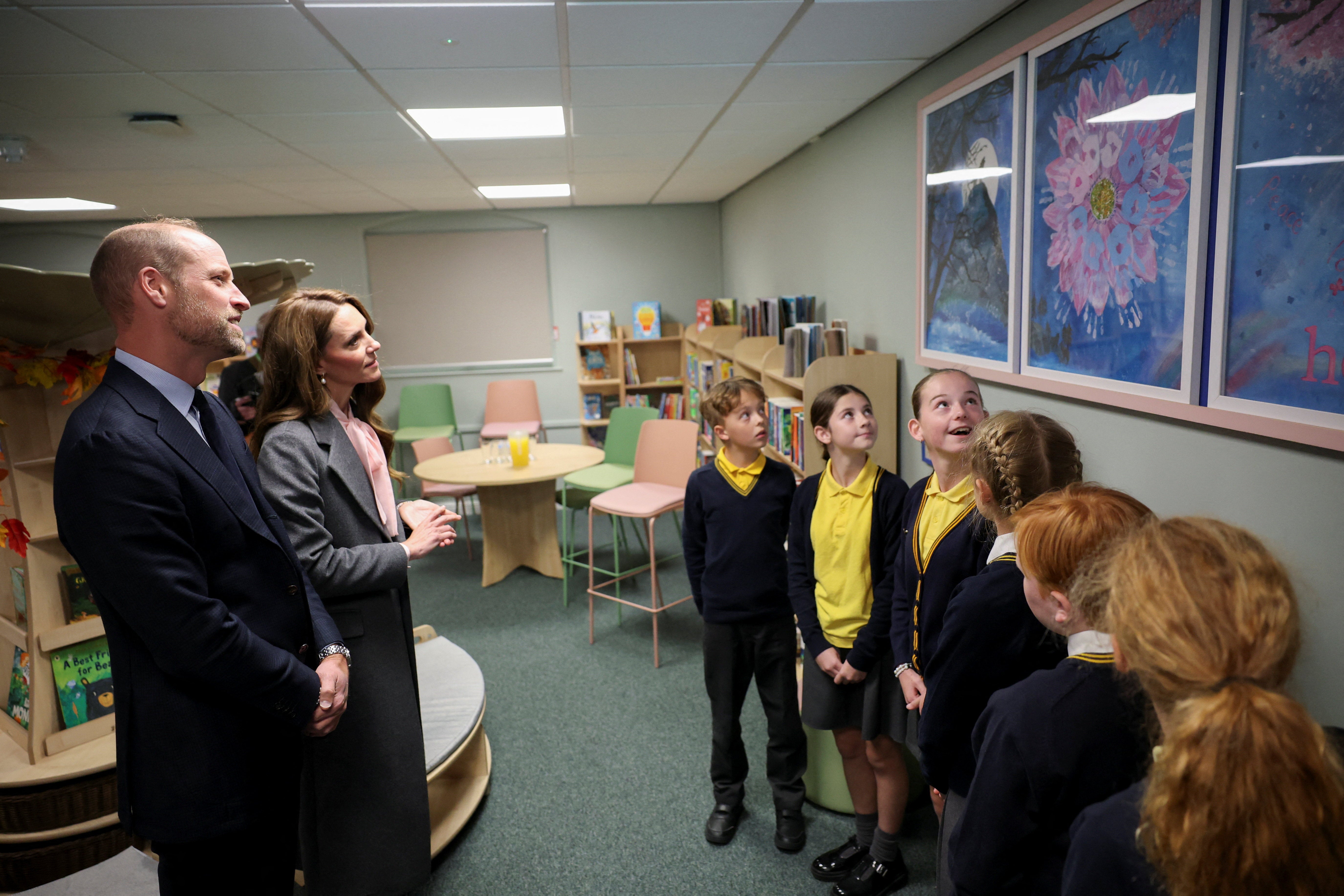 The Prince and Princess of Wales view paintings during a visit to Churchtown Primary School in Southport