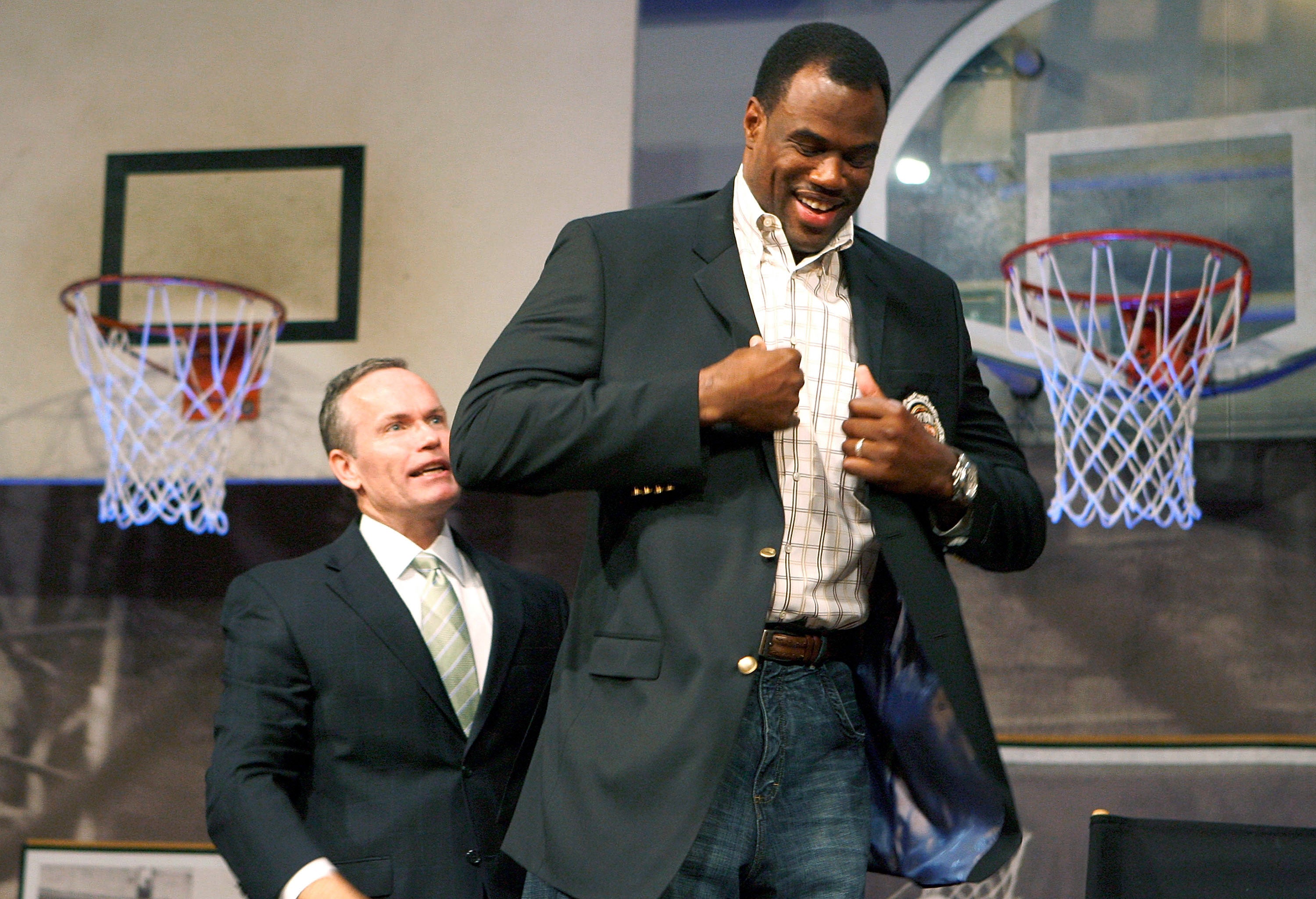 Basketball Hall of Fame president and CEO John Doleva (left) inducting NBA superstar David Robinson into the hall in 2009. A new federal lawsuit accuses Doleva of refusing to hire women