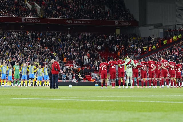 <p>Liverpool and Southampton players line up for a minute’s silence in memory of Matt Beard (Peter Byrne/PA)</p>