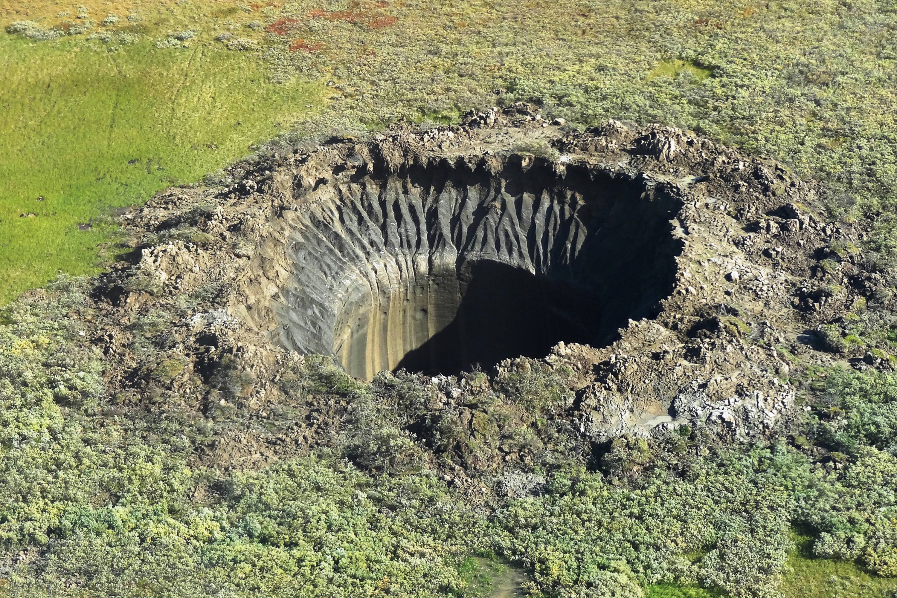 An aerial view from onboard a helicopter taken on August 25, 2014 shows a crater on the Yamal Peninsula, northern Siberia