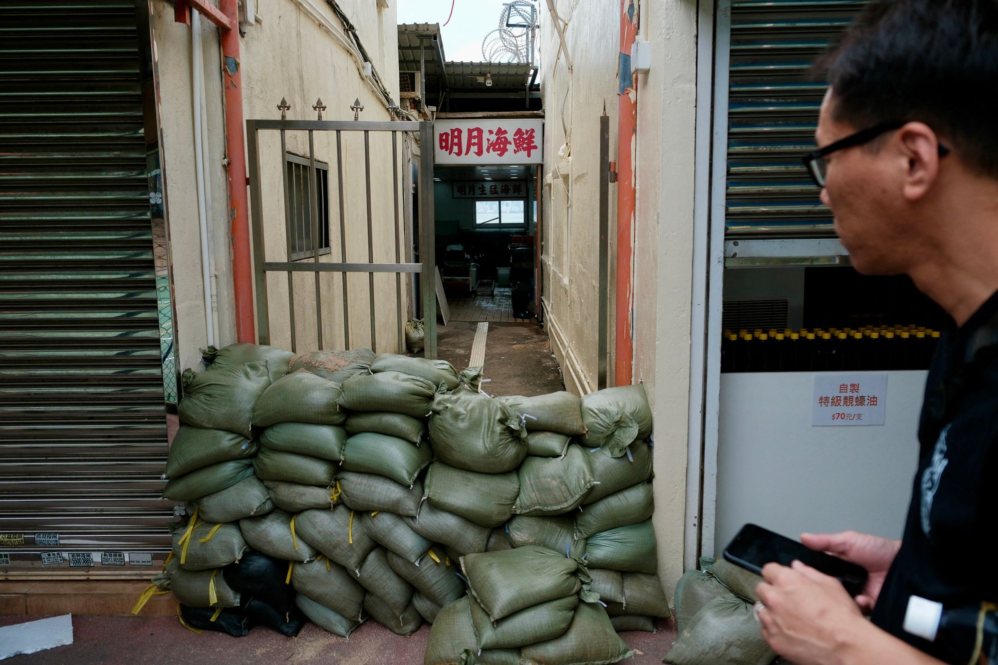 Stacked sandbags are laid in an alley in the coastal village of Lei Yue Mun as Ragasa approaches Hong Kong