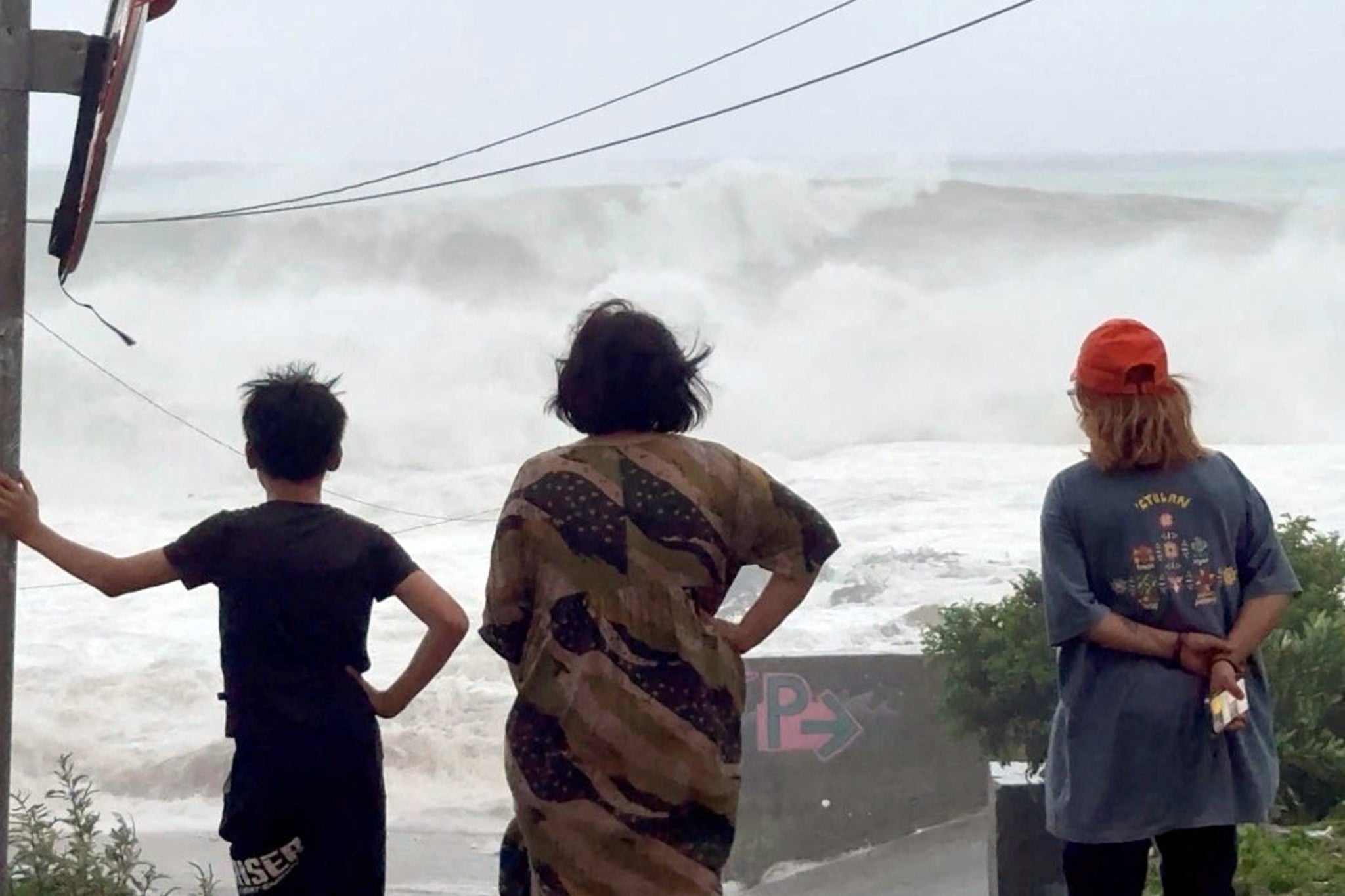 People watch huge waves crash ashore as Ragasa triggers heavy rain in Orchid Island, Taiwan