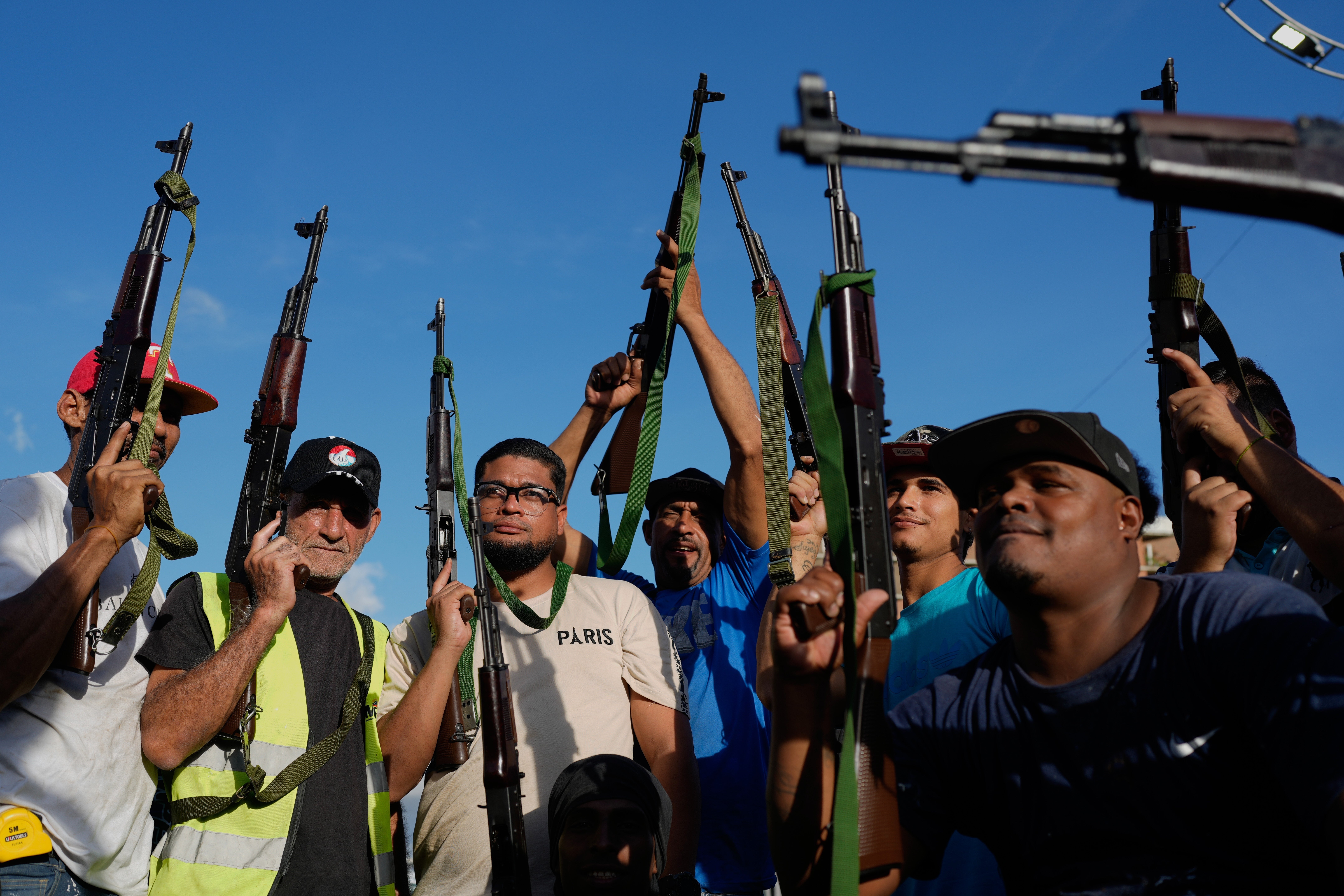 Armed demonstrators march in support of President Nicolas Maduro in Caracas, Venezuela.