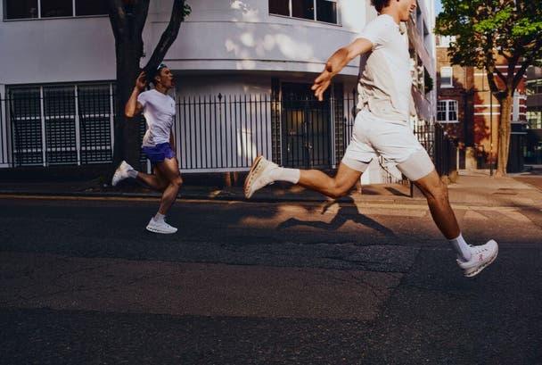 Two men running in the road
