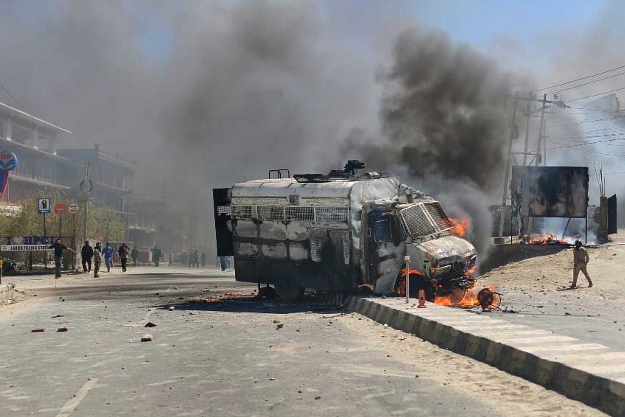 A police vehicle is set on fire during a protest in Leh town, Ladakh