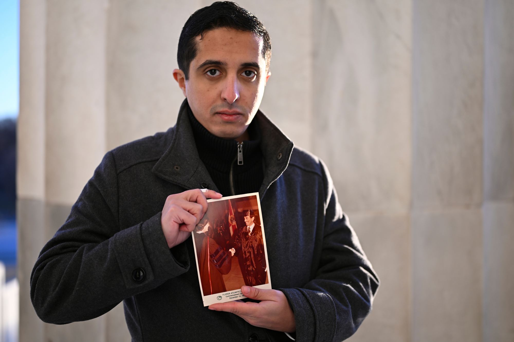Ibrahim Almadi holds a photo of his father Saad Almadi, who was convicted of cyber crimes after allegedly making critical posts about Saudi Crown Prince Mohammed bin Salman,