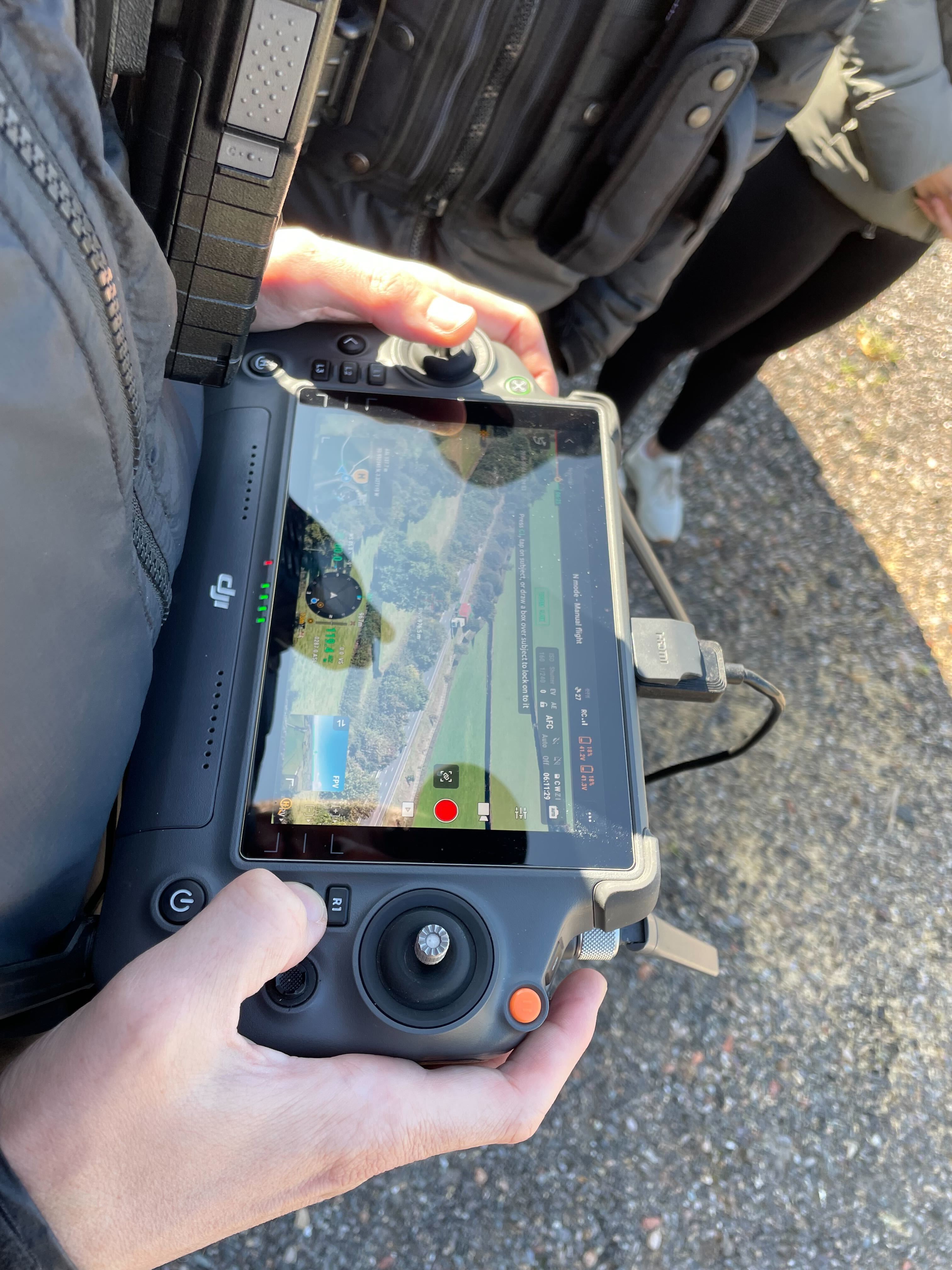 The drone is piloted using a large remote control pad