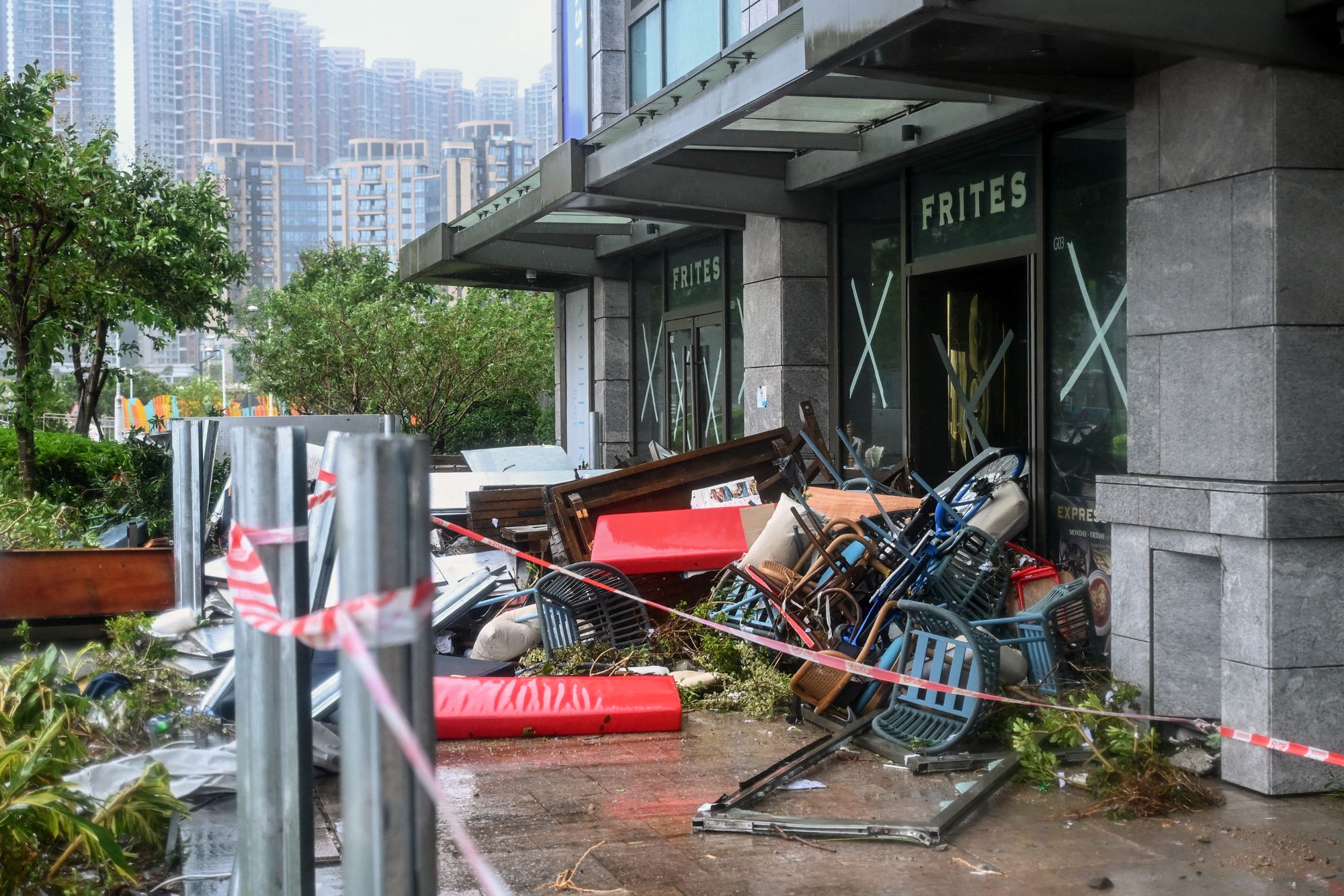 Debris is piled up in front of seafront restaurant in Tseung Kwan O damaged after Super Typhoon Ragasa hit the district in Hong Kong